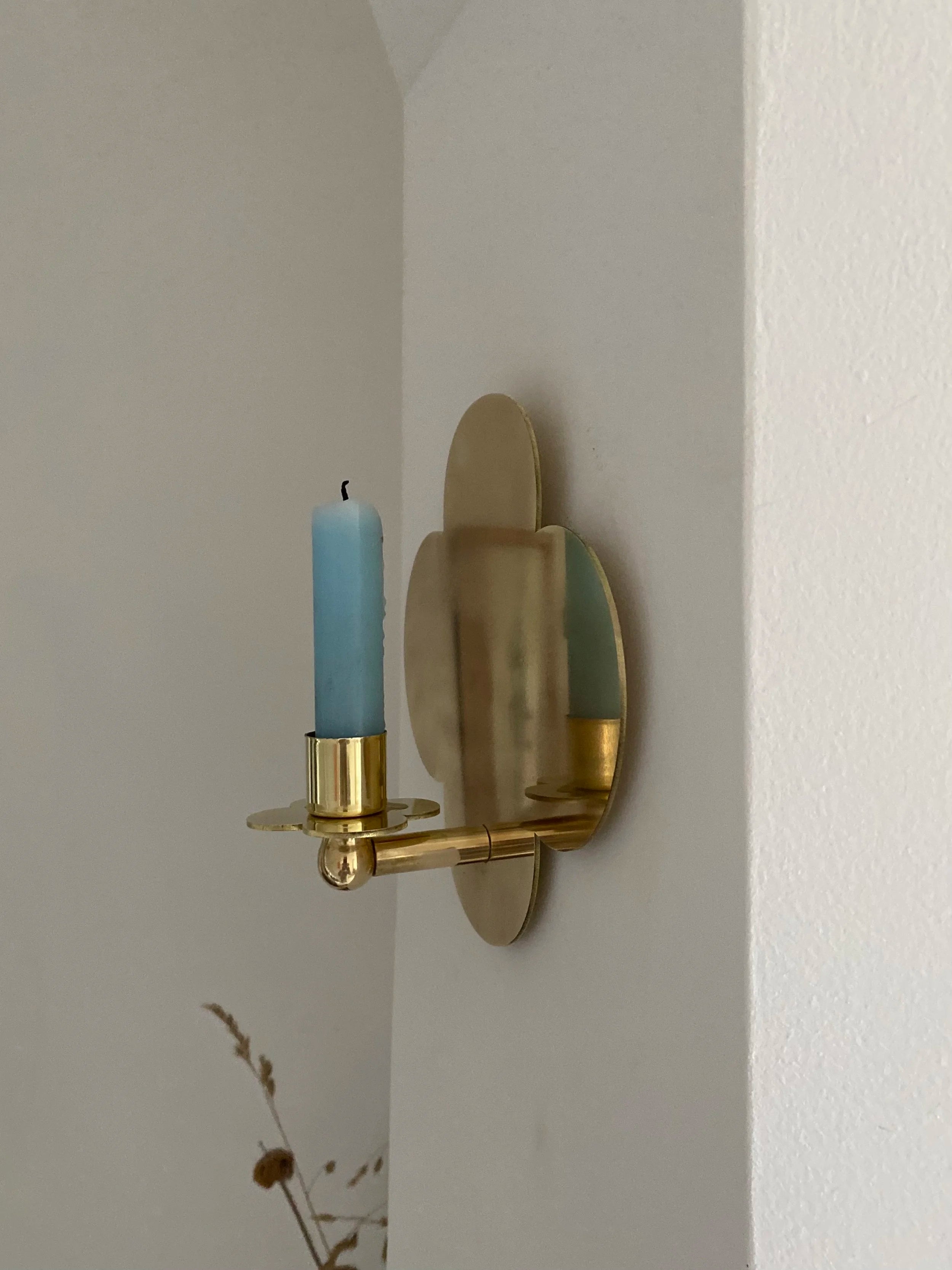 Quatrefoil Candle Sconce D:2023 — side view of brass sconce with blue candle
