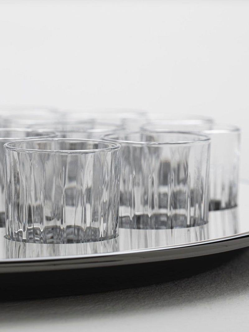 Round liquor serving set — close-up of clear glass tumblers on metal tray
