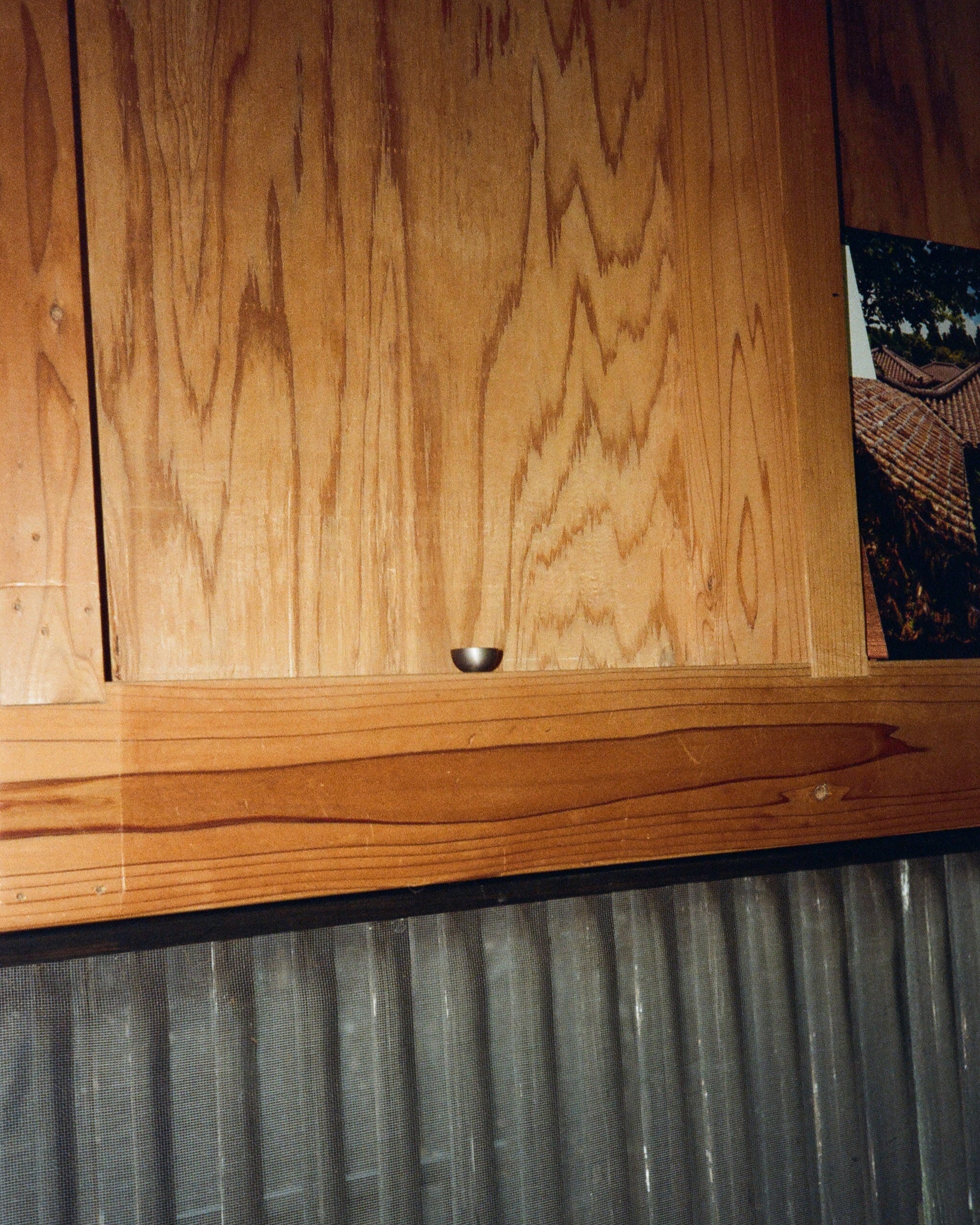 CERCLE Cabinet Knob Half — top view on wooden cabinet surface