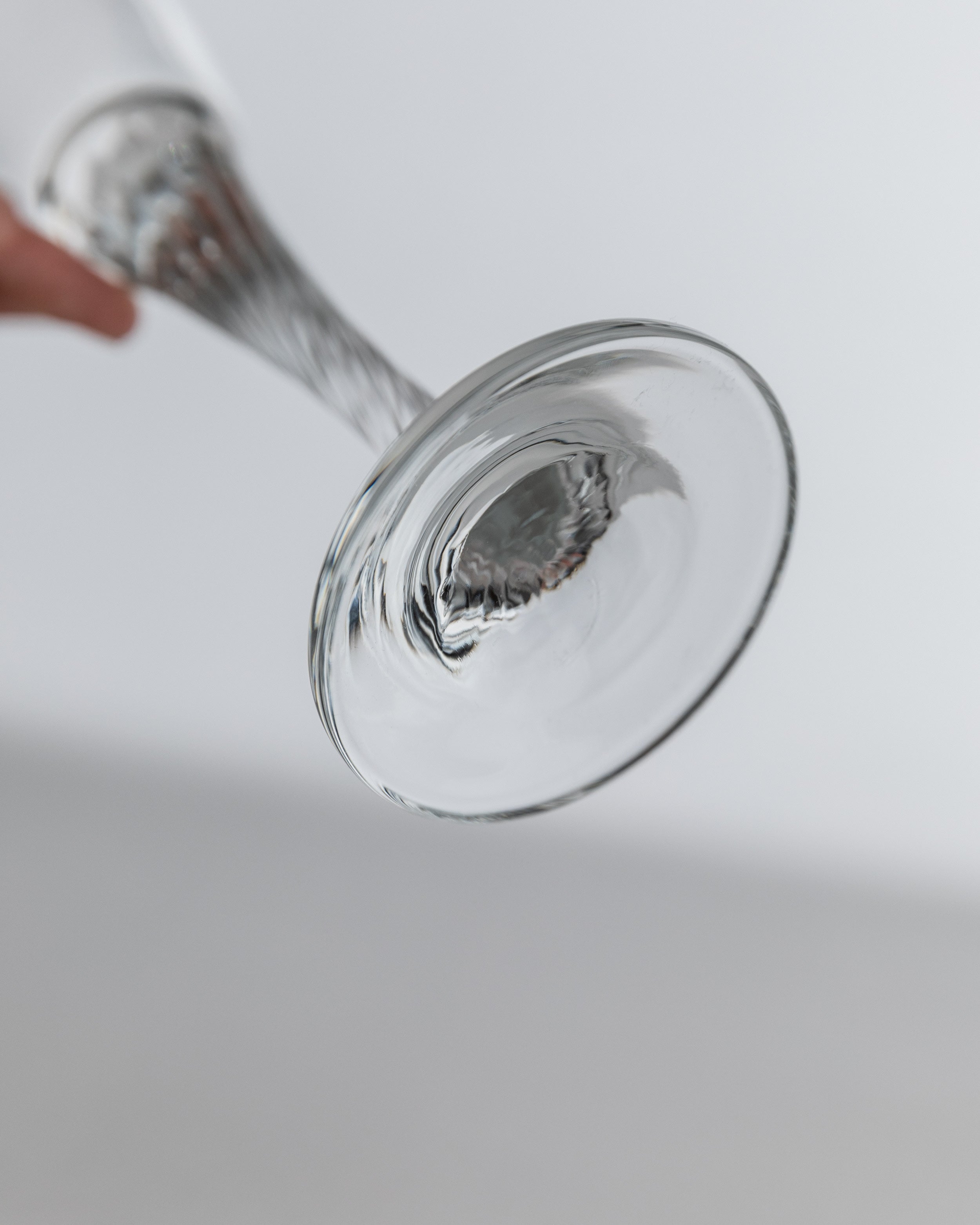 Close-up view of 1980s champagne coupe base and stem detail