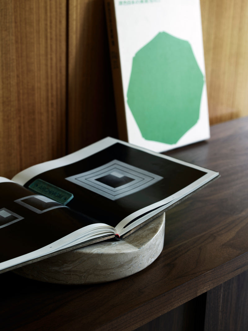 Fane marble bookstand with open book in modern interior setting
