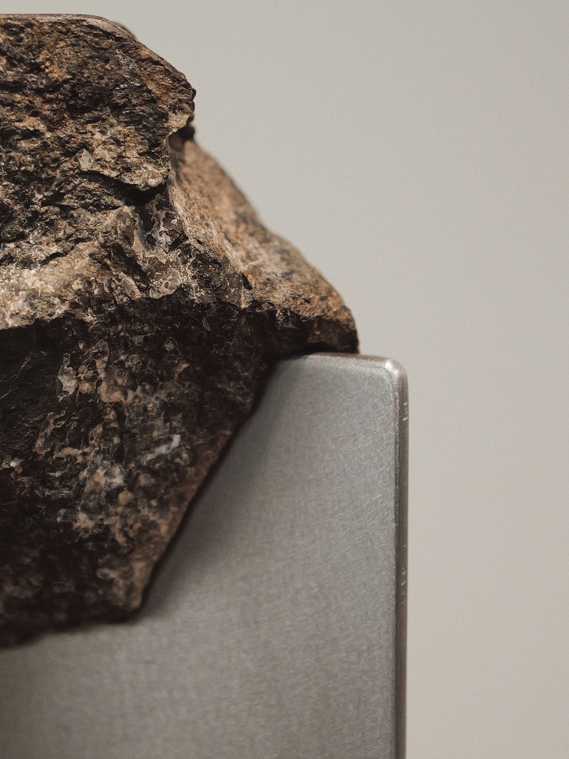 Close-up detail of raw stone balanced on Hybrid Objects side table