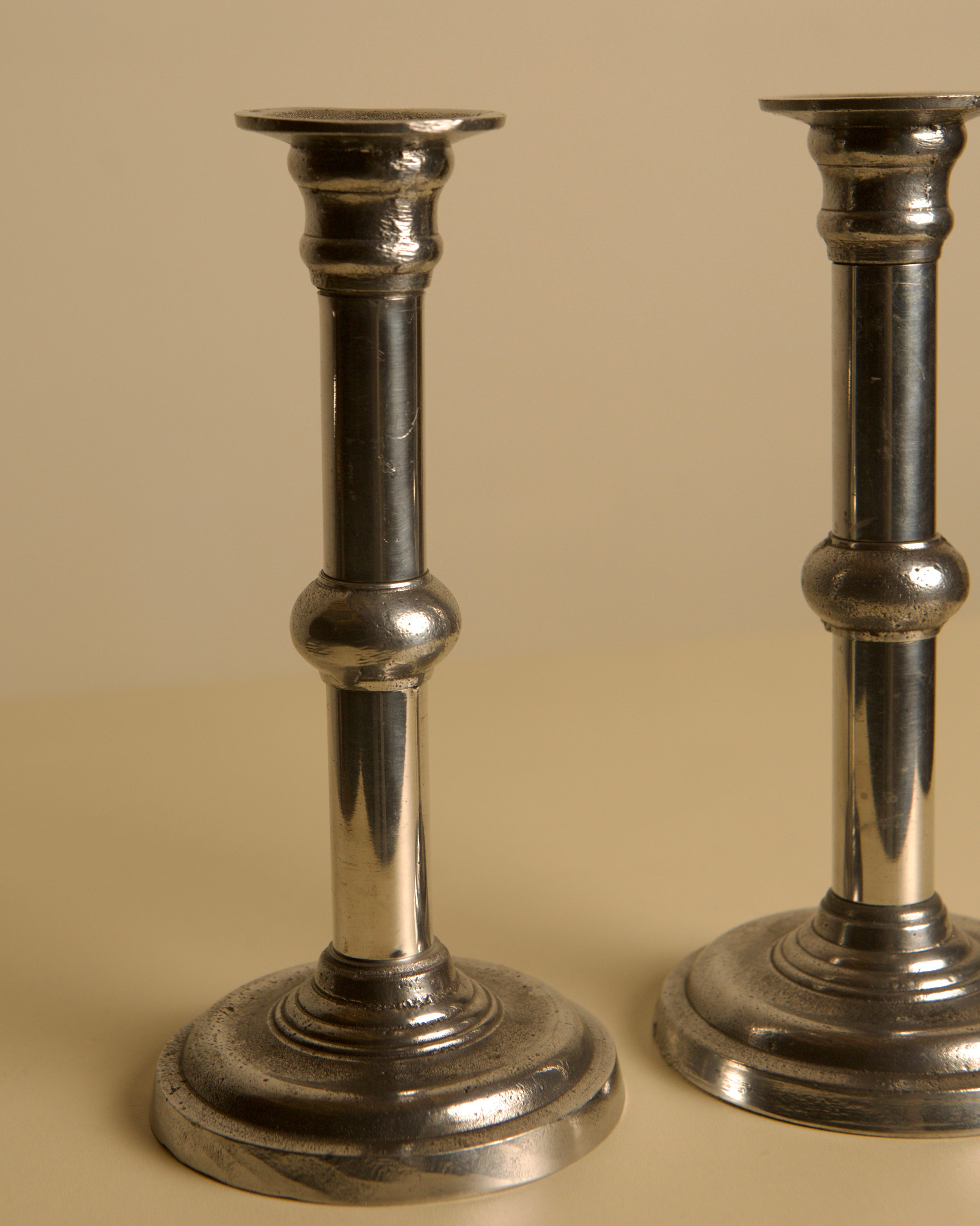 Pair of Italian Metal and Aluminum Candleholdersc80s — side angle showing polished metal finish