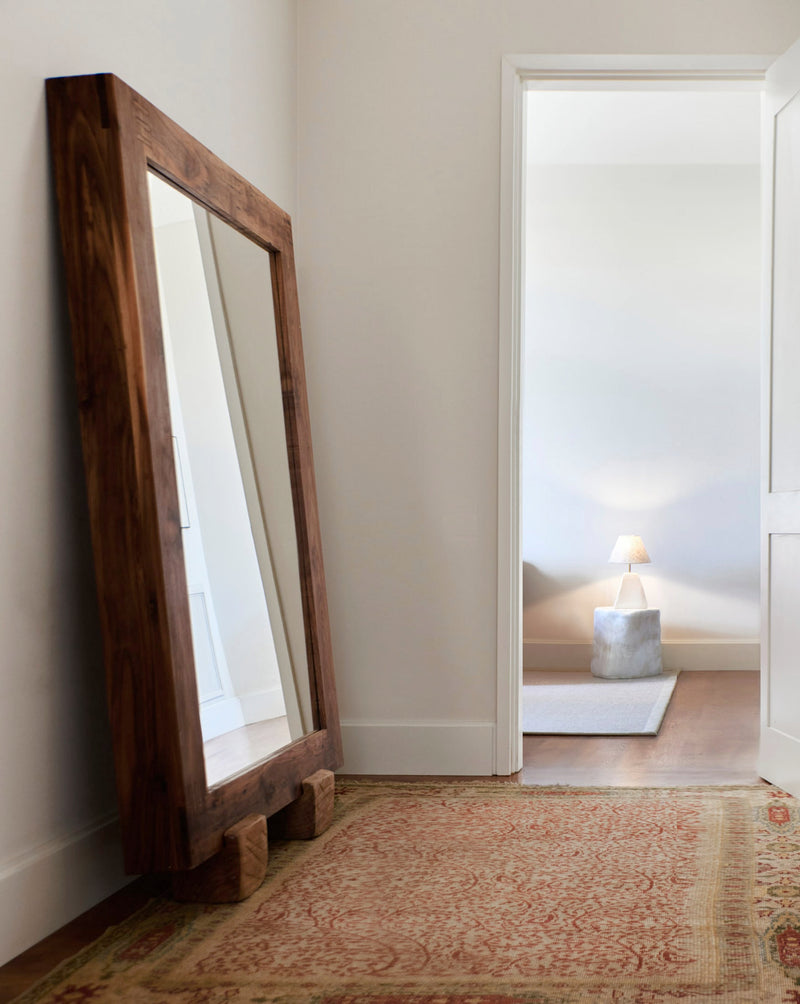 Olá Mirror — angled view against a neutral wall