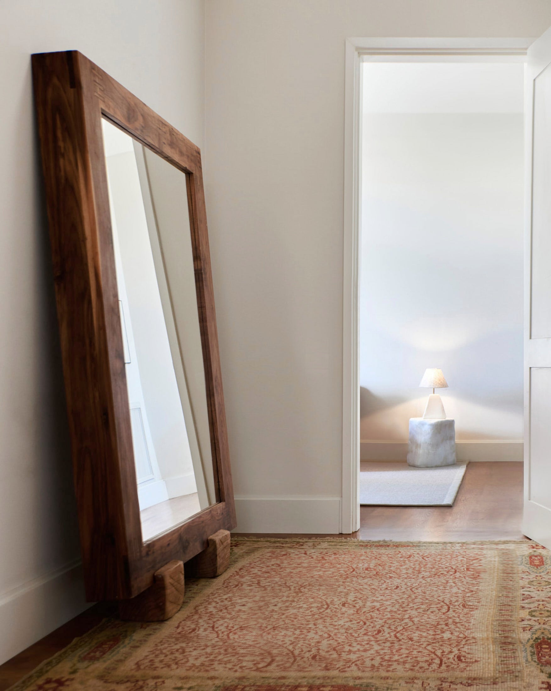 Olá Mirror — angled view against a neutral wall