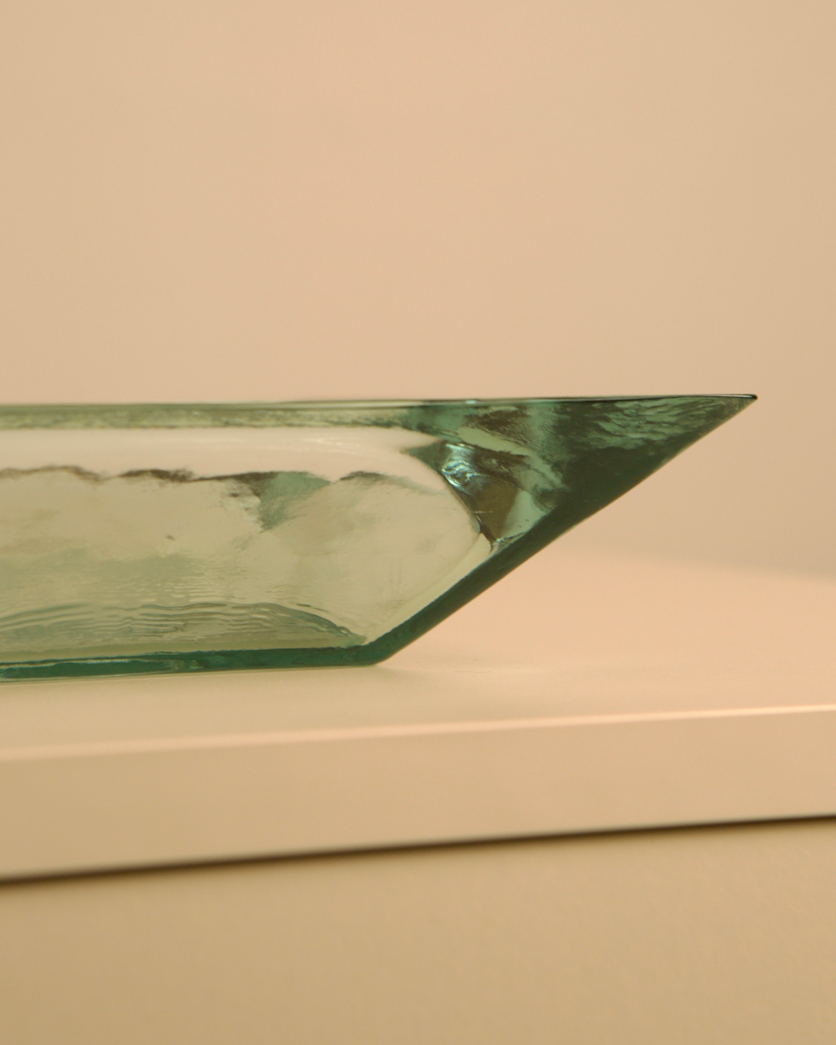Large Italian glass basket by Fontana Arte — angled view on light surface