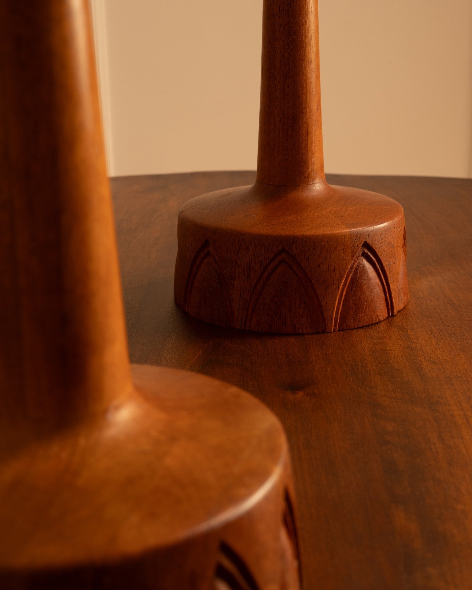 Detail view of Swedish teak table lamp bases with carved patterns