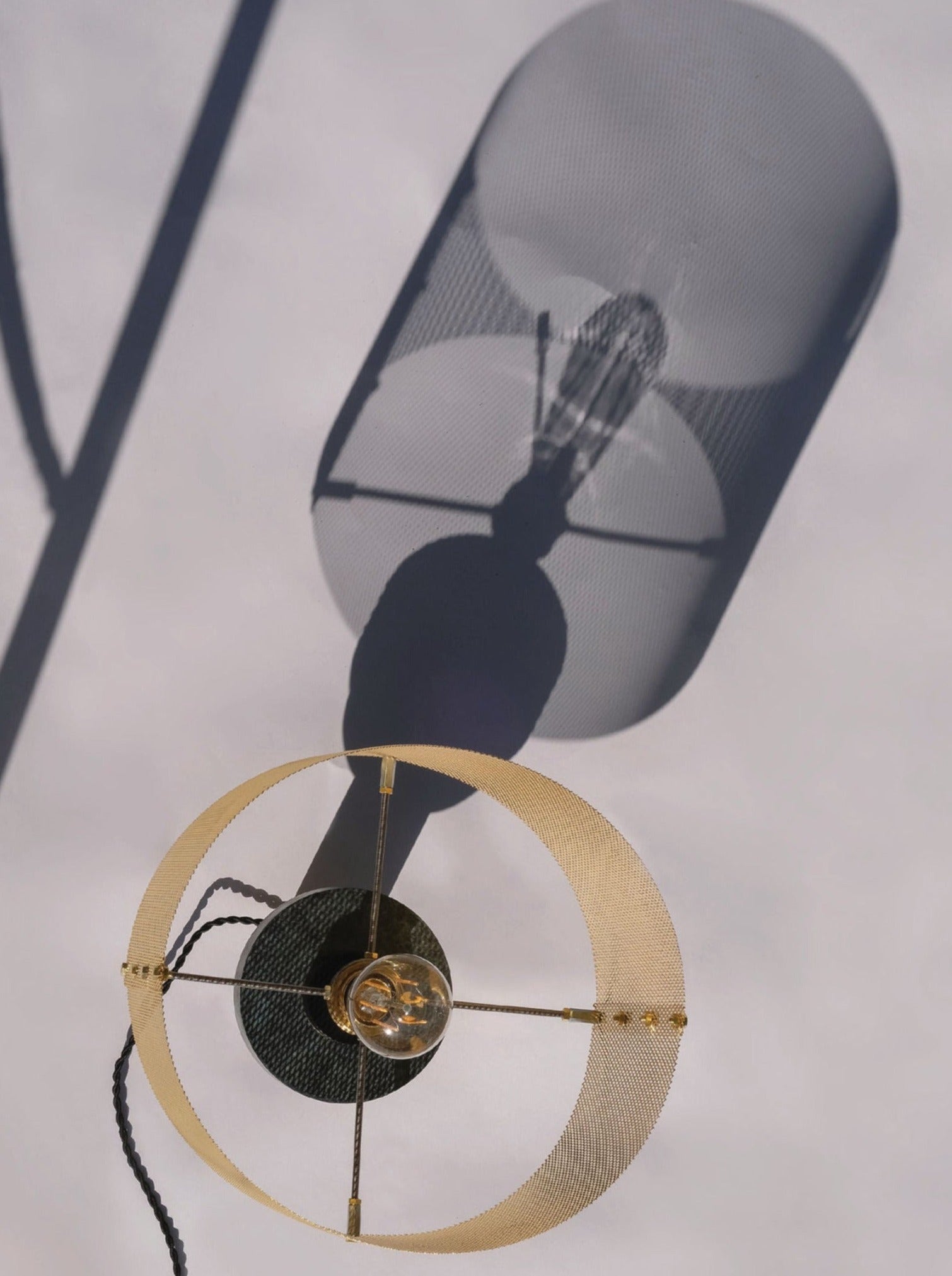 Dyane Table Lamp — overhead view with gold circular base and shadow