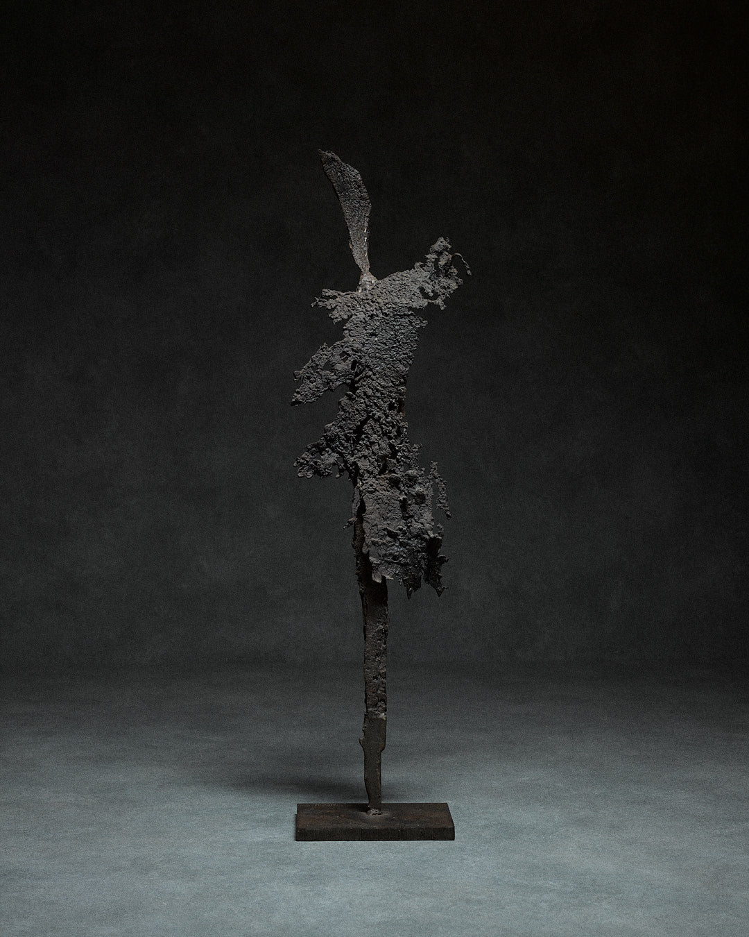 Skeletal Sculpture in Iron by Francois Saison — full view against dark background