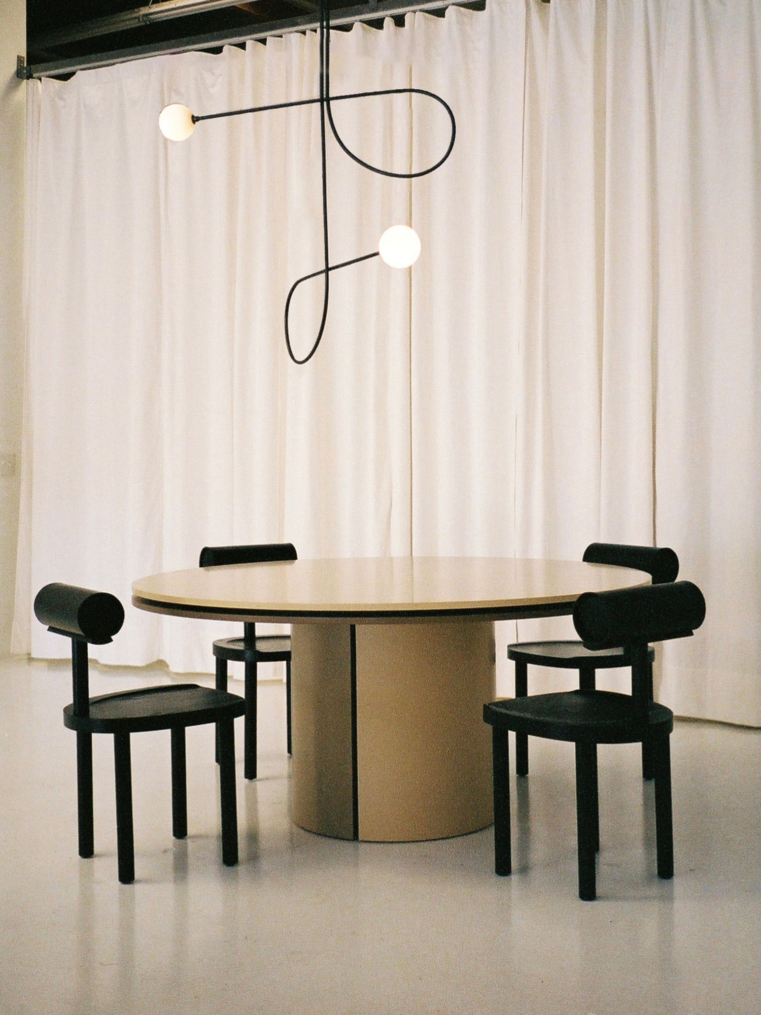 UNA Chair by Estudio Persona — black leather chair in modern dining setting