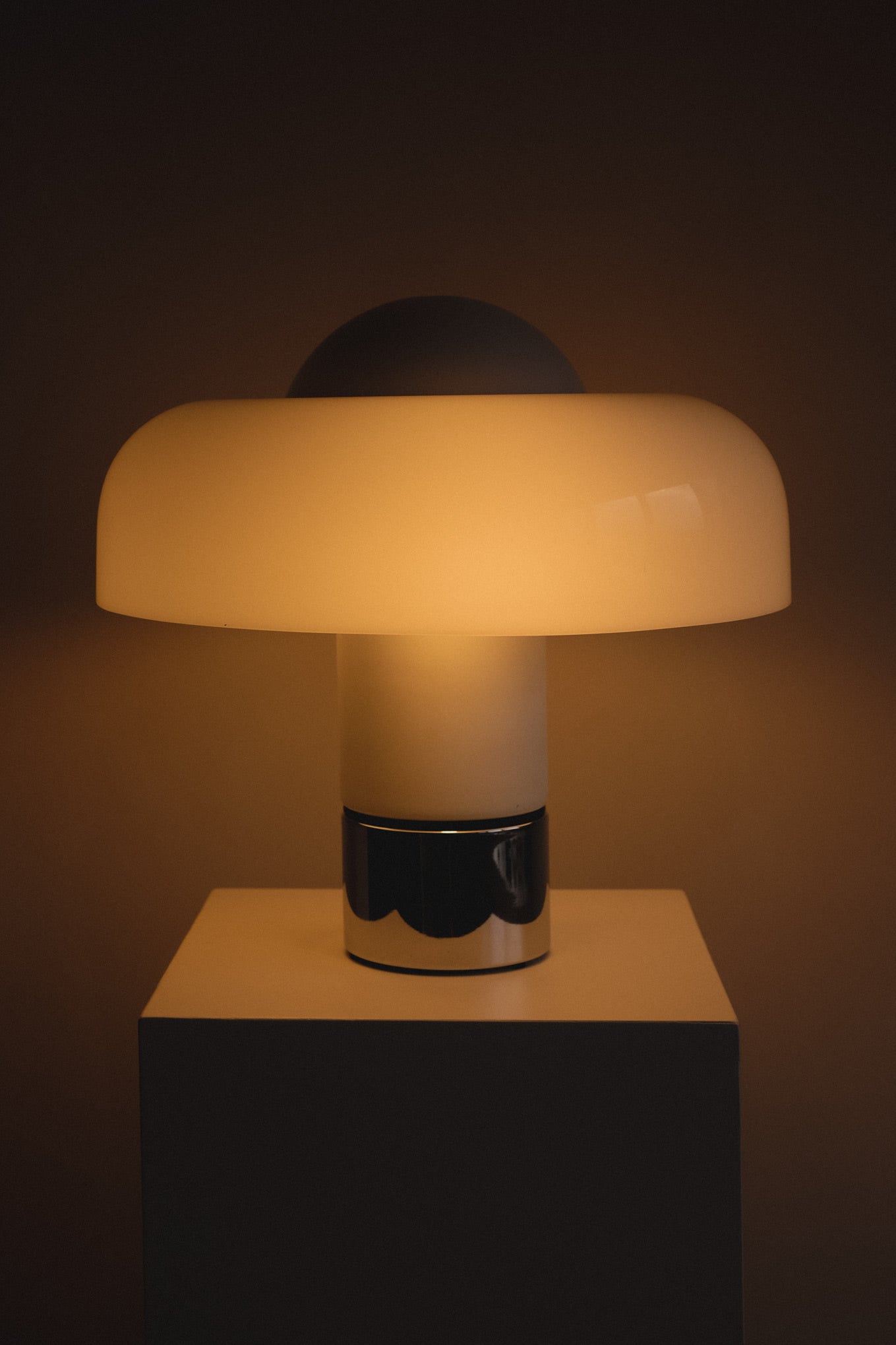 Brumbry Table Lamp by Luigi Massoni for Harvey Guzzini — back view with glowing white shade