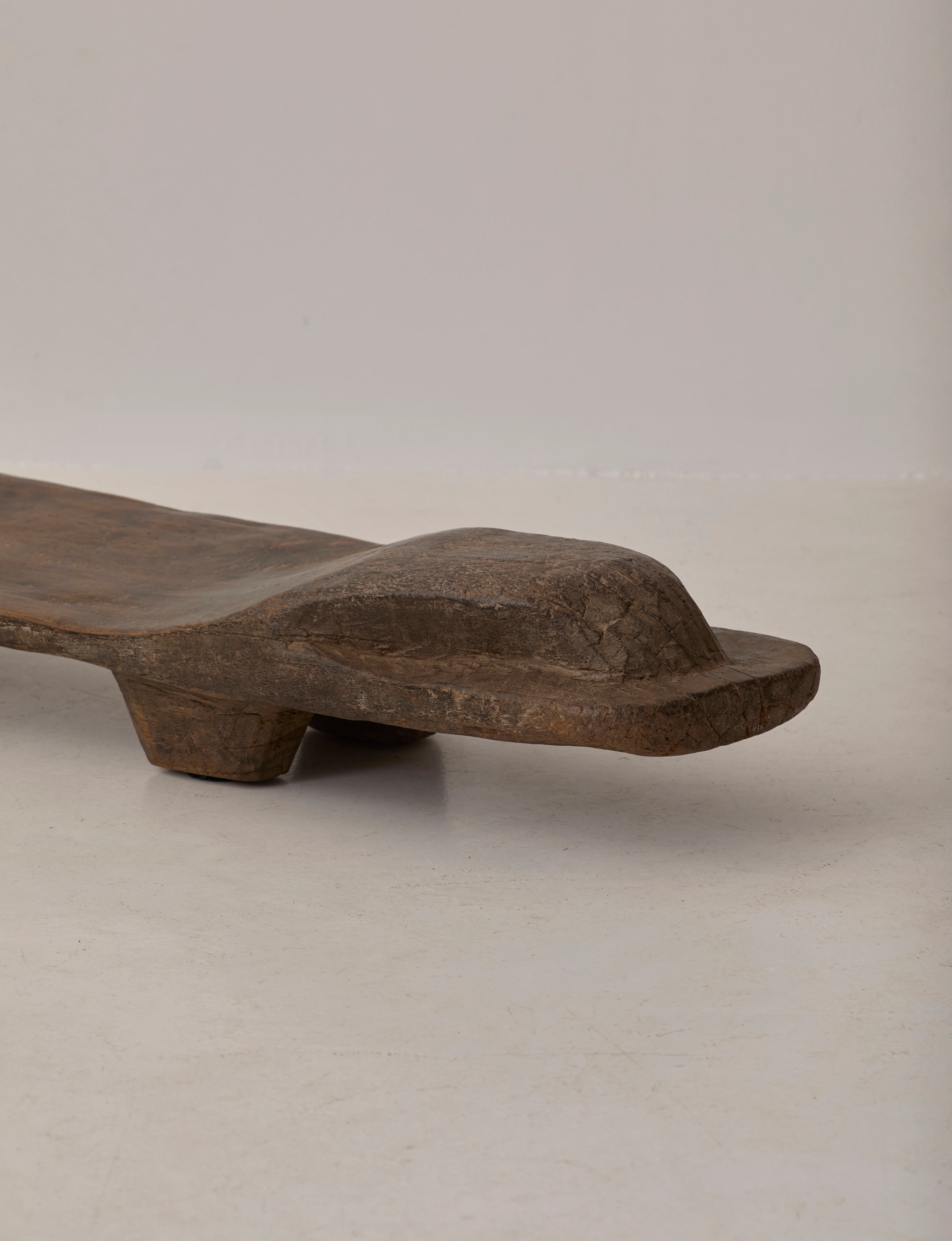 Carved Senufo Bench in Wood — back view highlighting natural wood grain