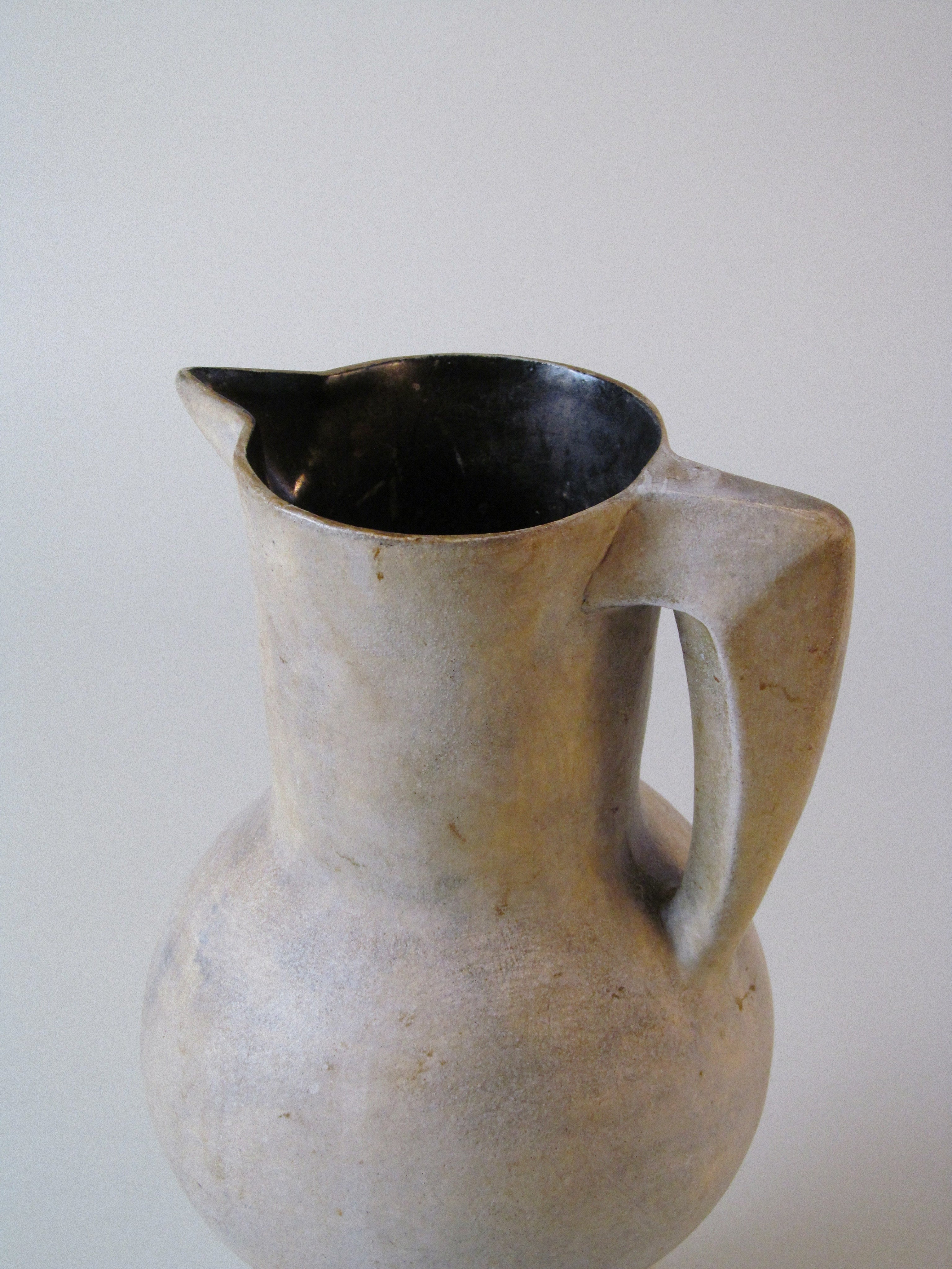 Stoneware Pitcher — angled view highlighting matte gray finish