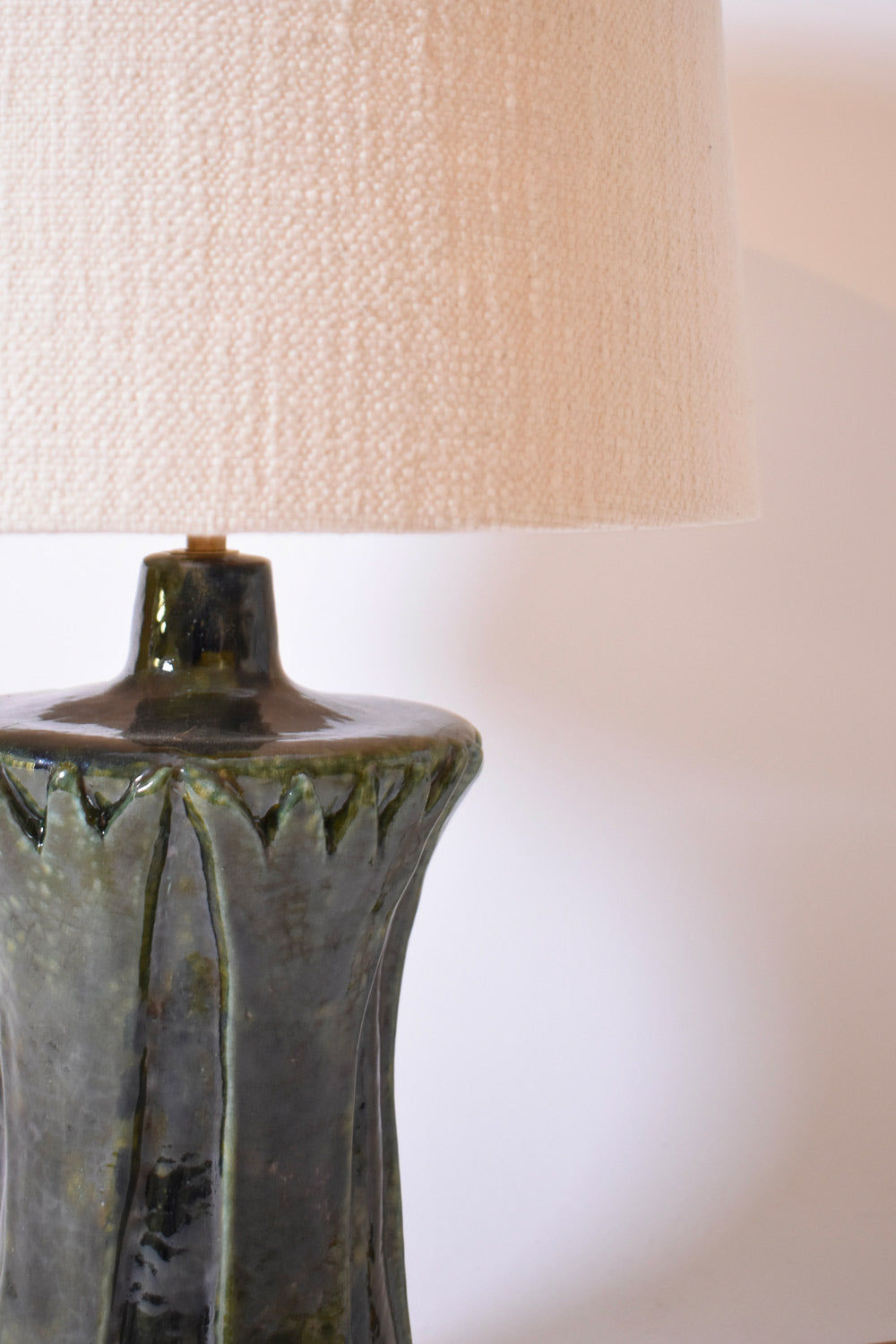 A close-up of the Barracuda Interiors "Kasaï" Blue Green Papyrus Ceramic Lamp, showcasing its textured, glossy blue green base and cream fabric shade against a plain light background.