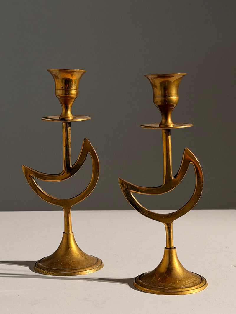 Pair of brass candlesticks with a crescent-moon motif, France, circa 1970 — detail view