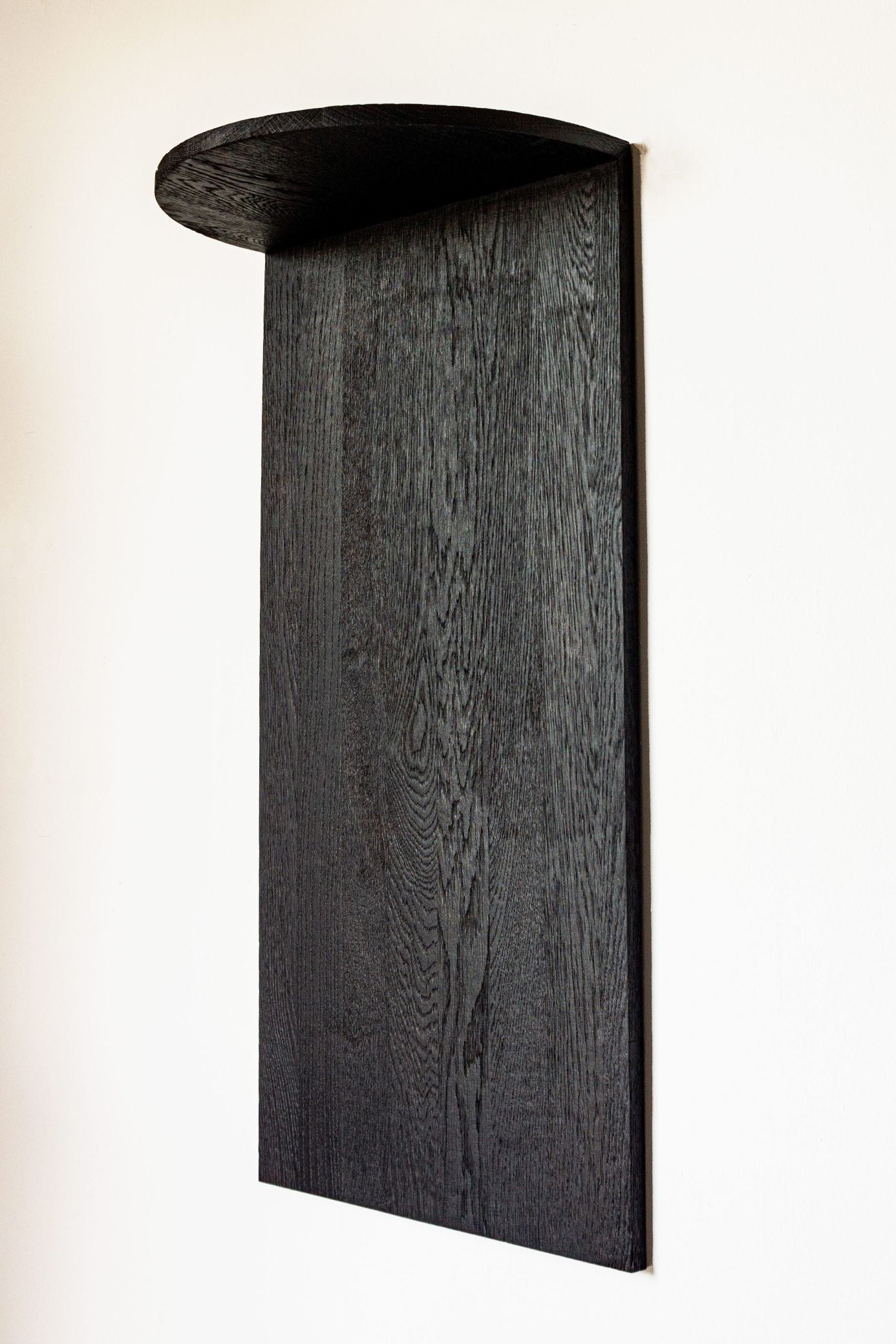 Megaron black oak wall shelf with curved top detail view