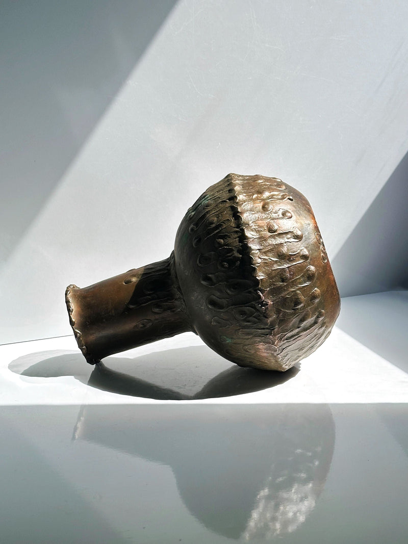 Hammered copper vase detail showing textured metalwork craftsmanship