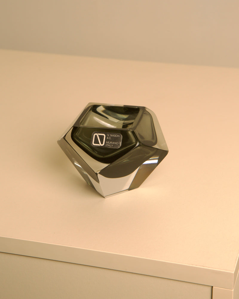 Black faceted Murano glass diamond vide poche on white surface