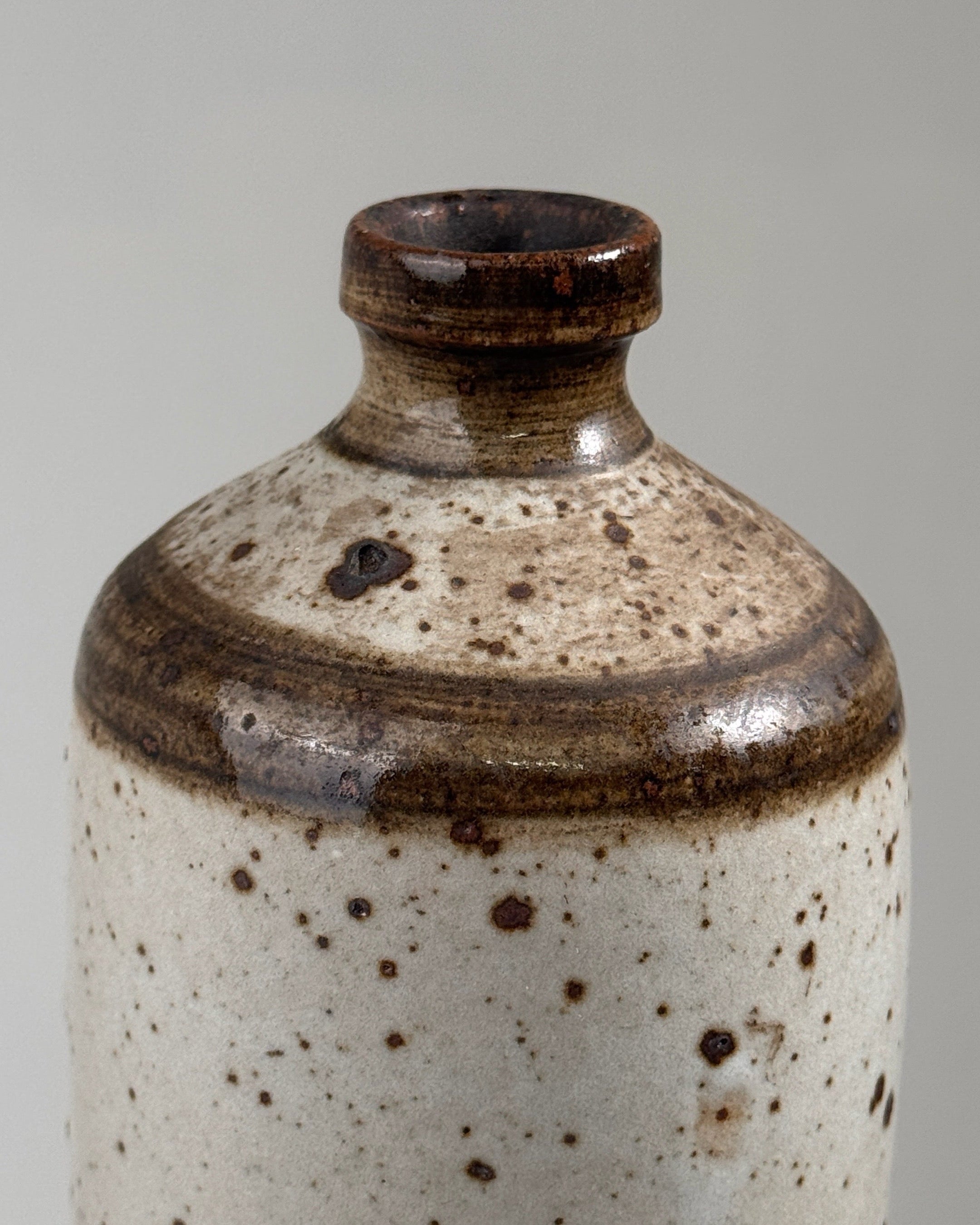 Pyrited stoneware bottle detail showing speckled glaze texture