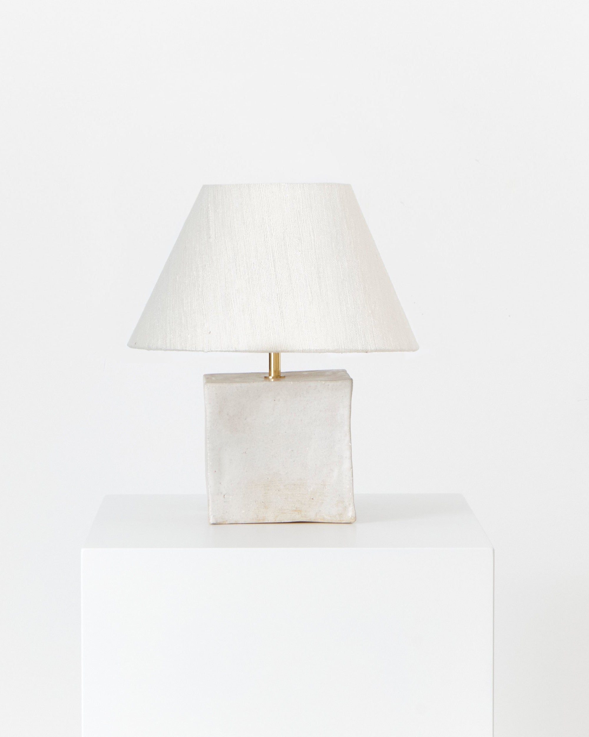 Arouca Table Light White — side angle showing textured base and fabric shade