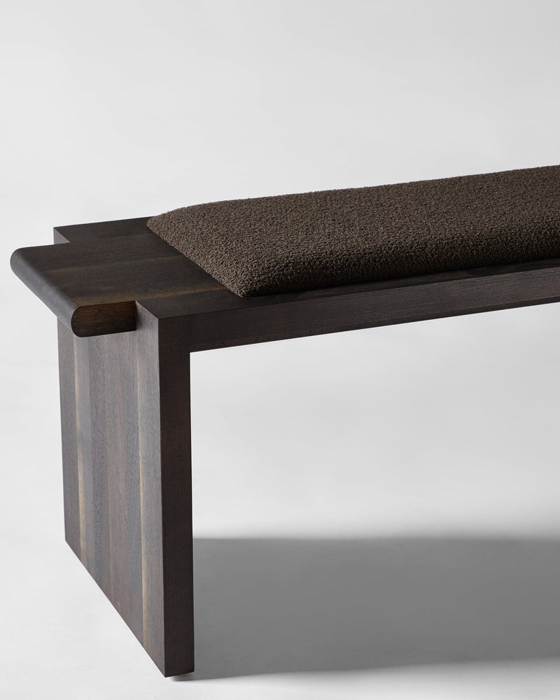 Upholstered Plank Bench — close-up of dark wood frame and brown cushion