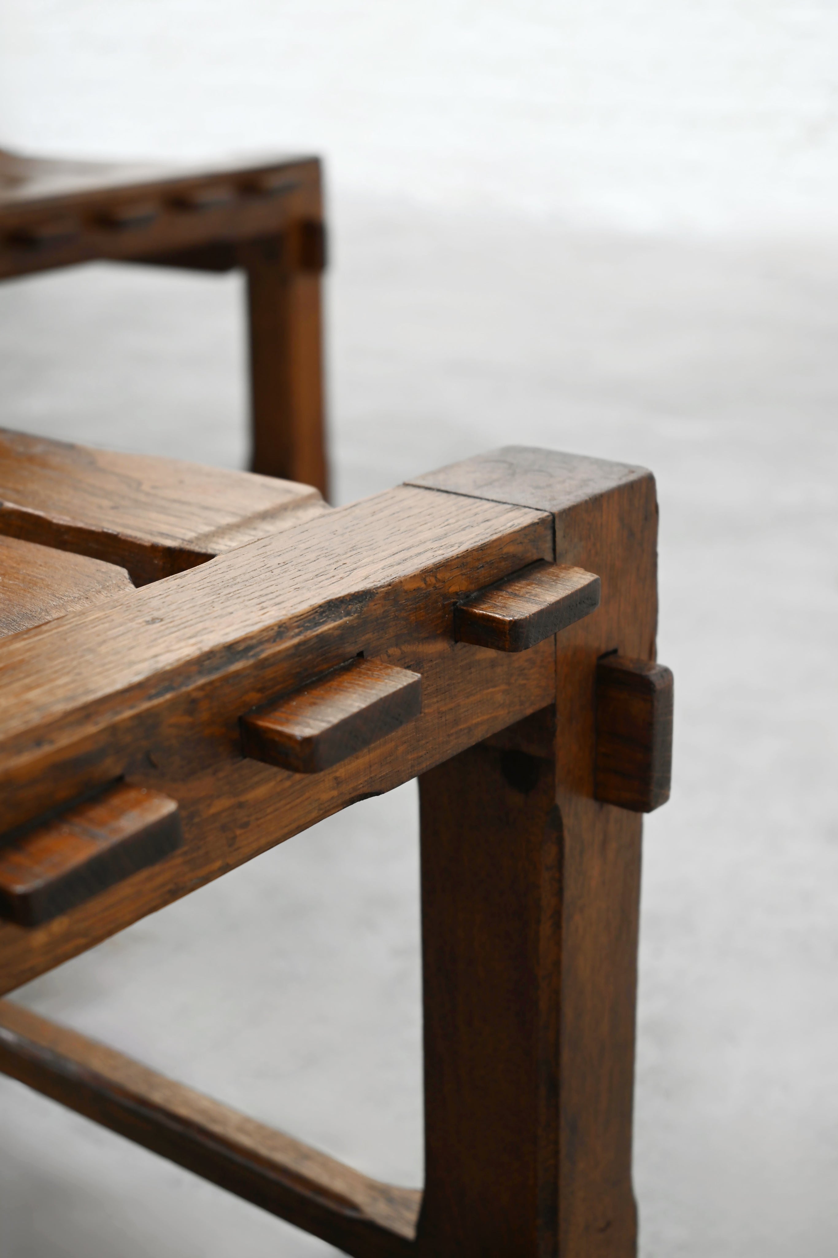 Close-up detail of solid oak joinery on 1970s brutalist chair