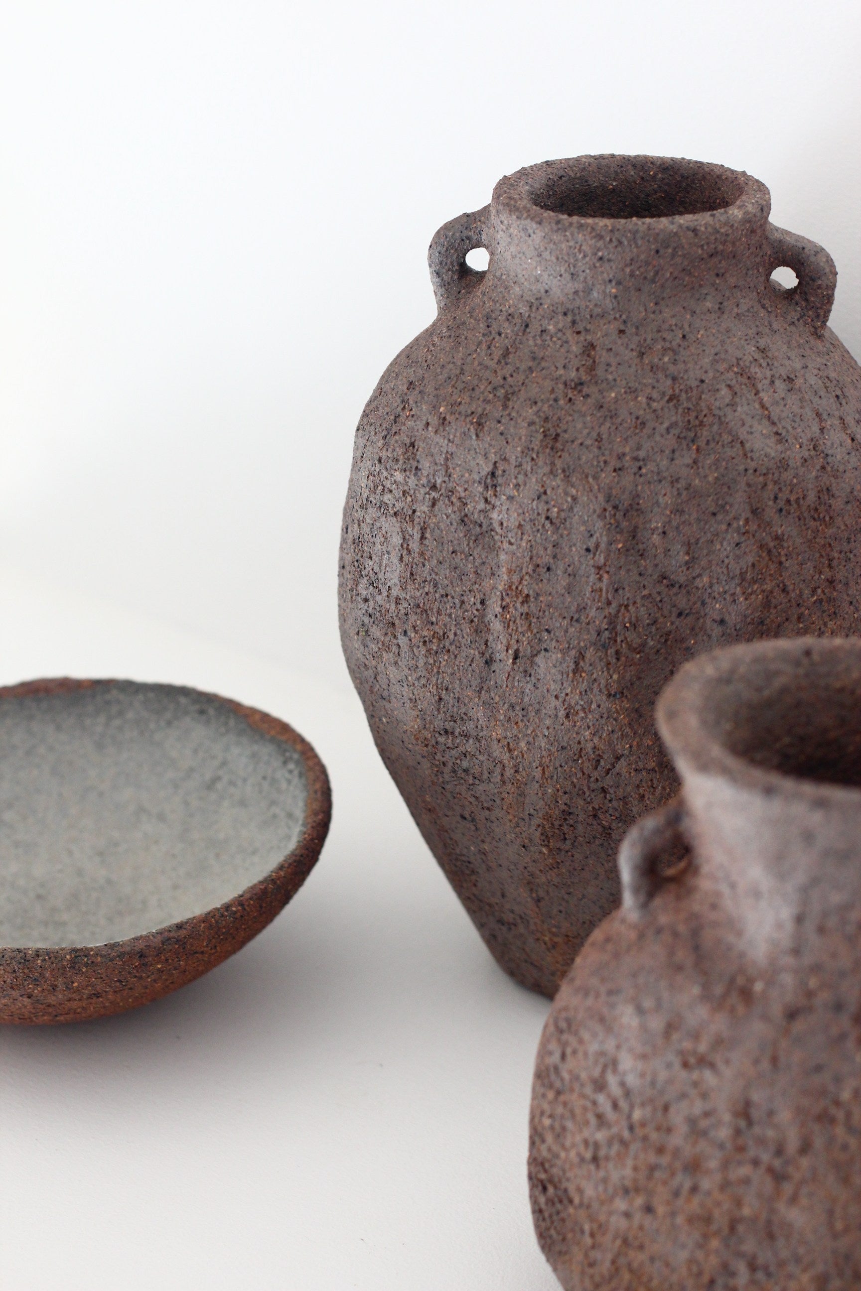 Stoneware Vase Ash 01 — close-up of textured gray stoneware in minimalist setting