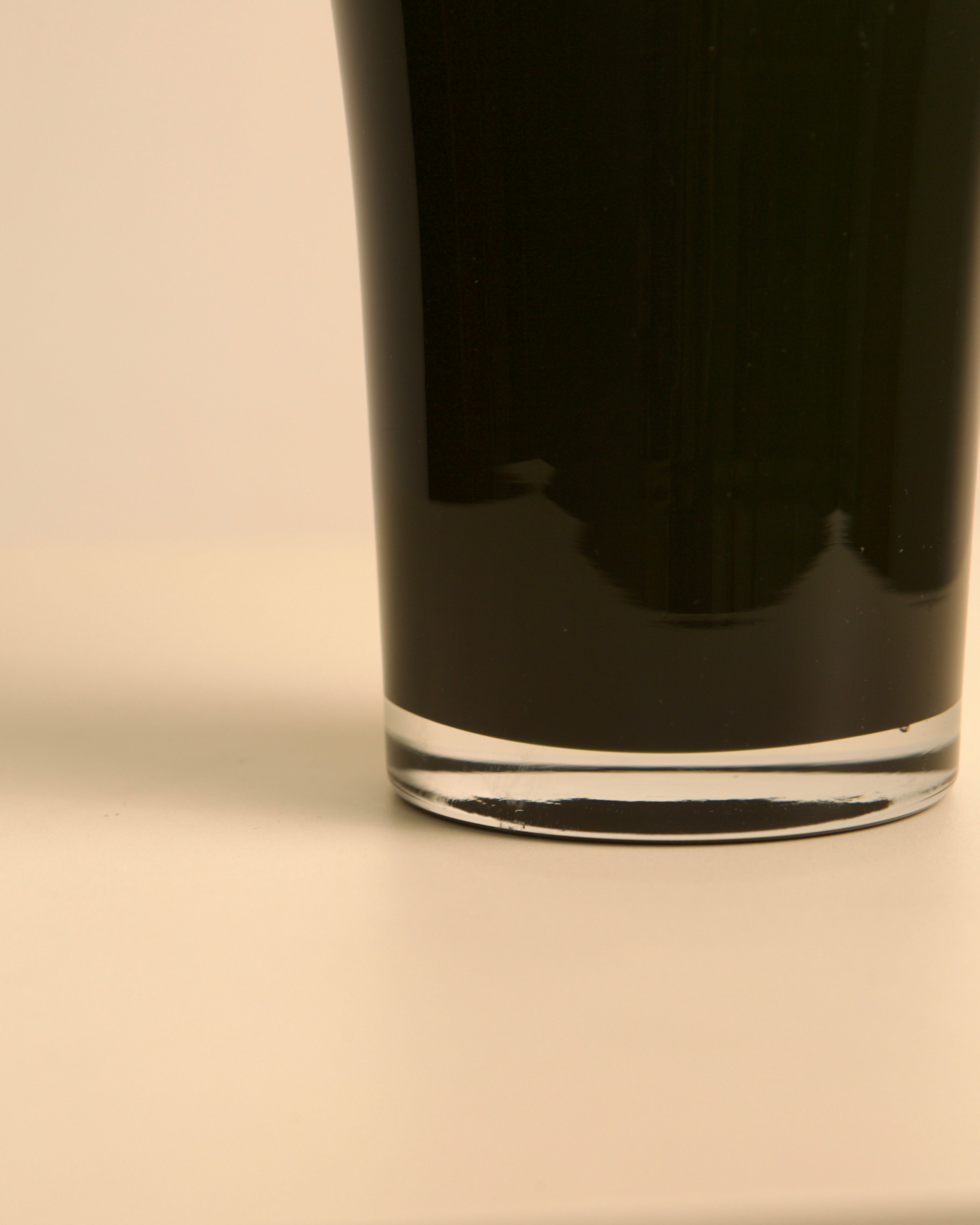 Close-up detail of Italian black Murano glass vase base