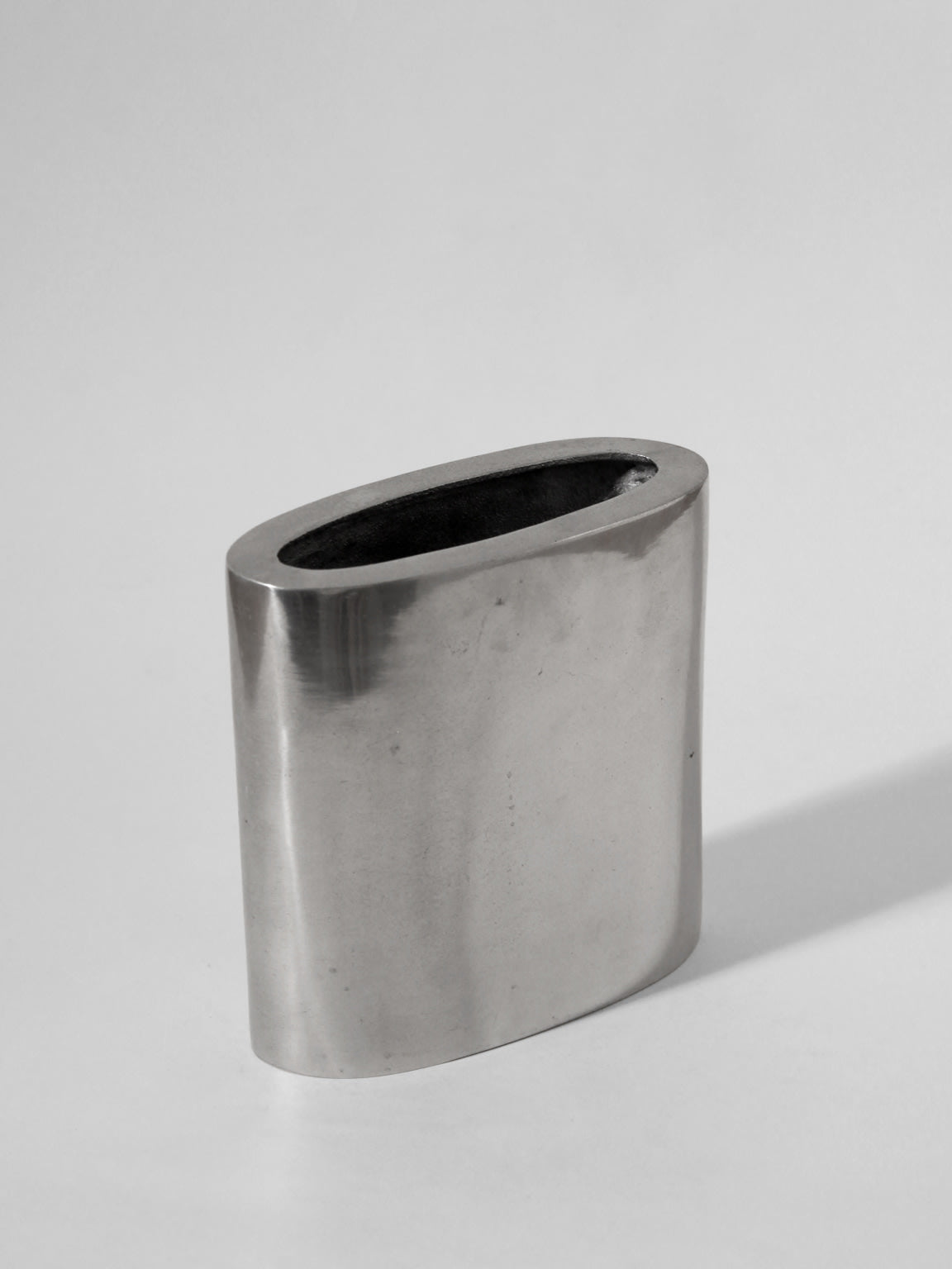 The Vintage Stories Polished Aluminum Square Flat Vase features a sleek, metallic finish and modern design, displayed upright against a plain light gray background.