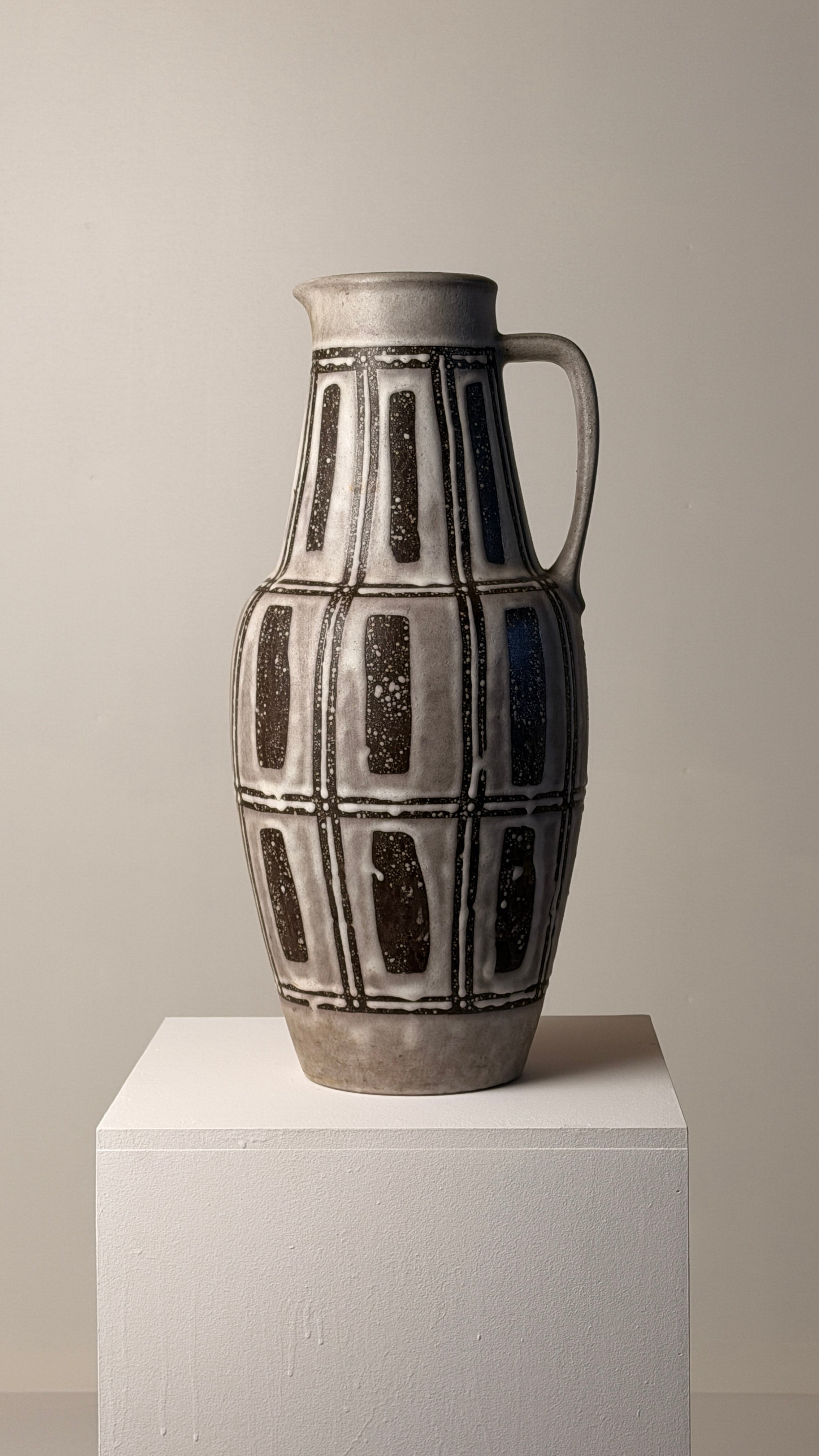 Ceramic pitcher, Germany, circa 1960 — side view on white pedestal