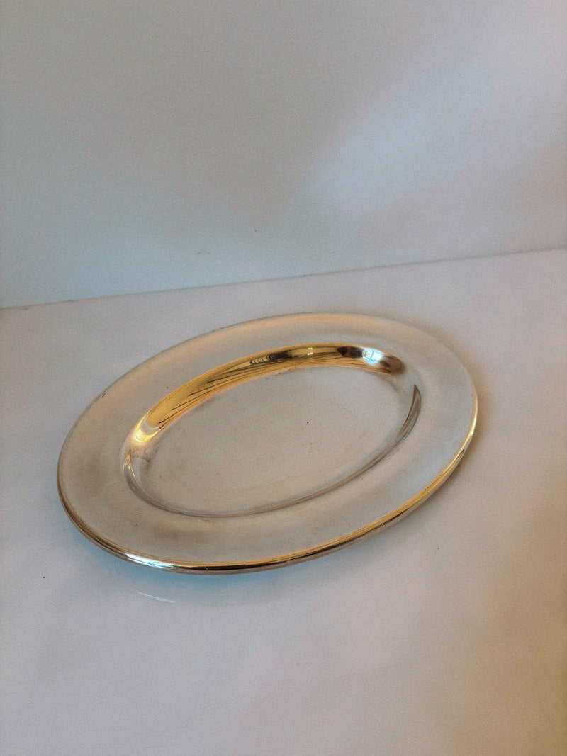 Silver plated oval serving platter detail view on white surface