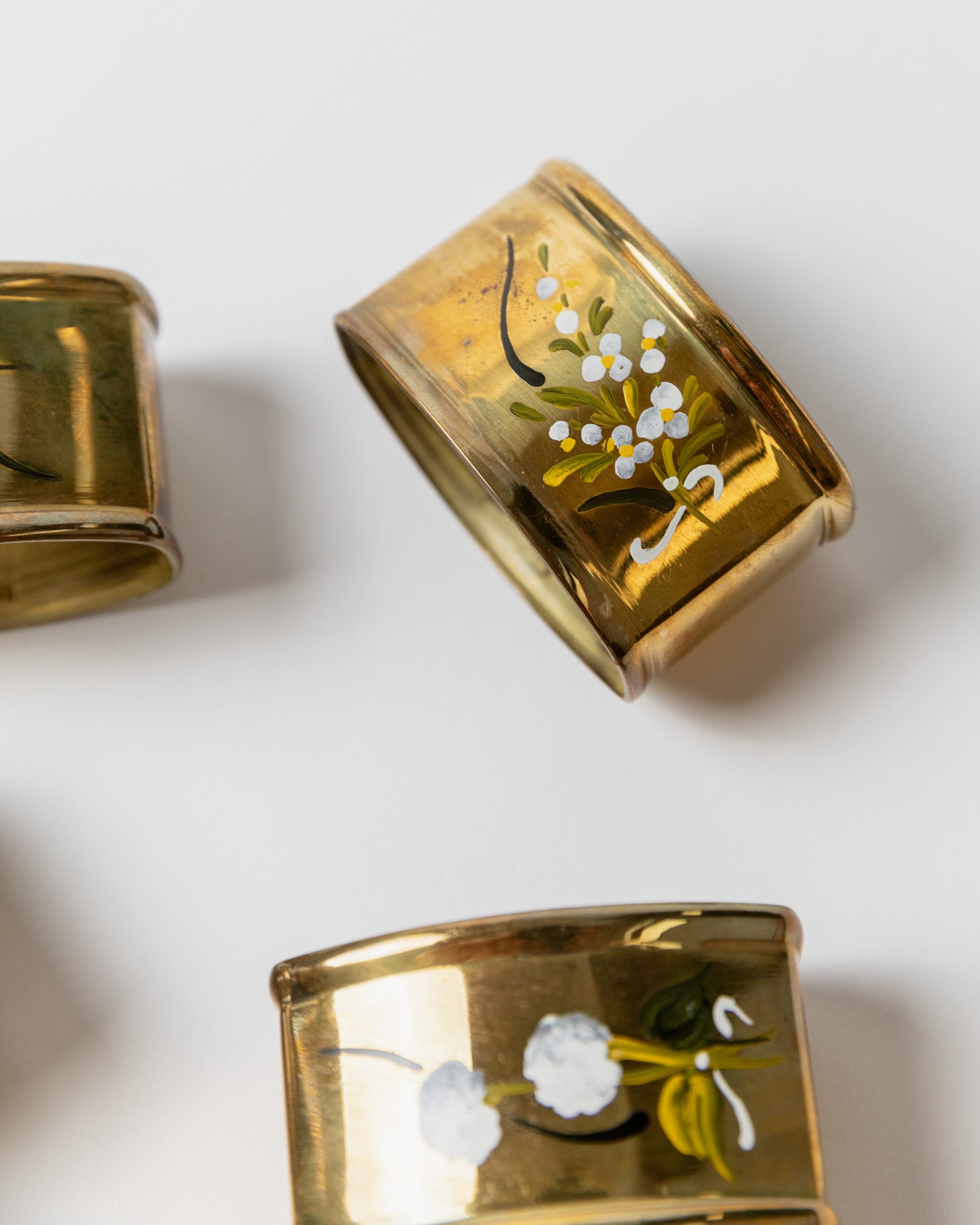 Decorative detail of vintage brass napkin rings with floral motifs