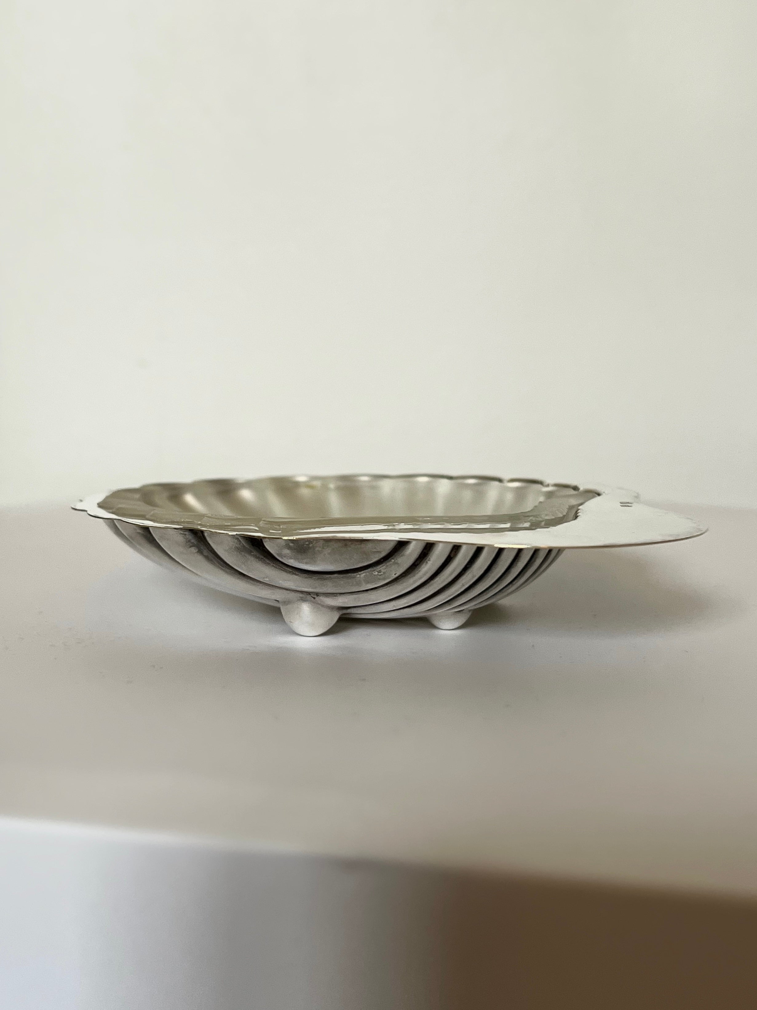 Exquisite silver shell shaped dish, perfect for serving elegant appetizers