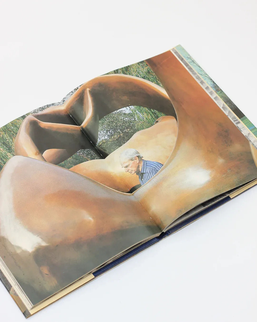 With Henry Moore' Art Book — open view showing bronze sculpture detail
