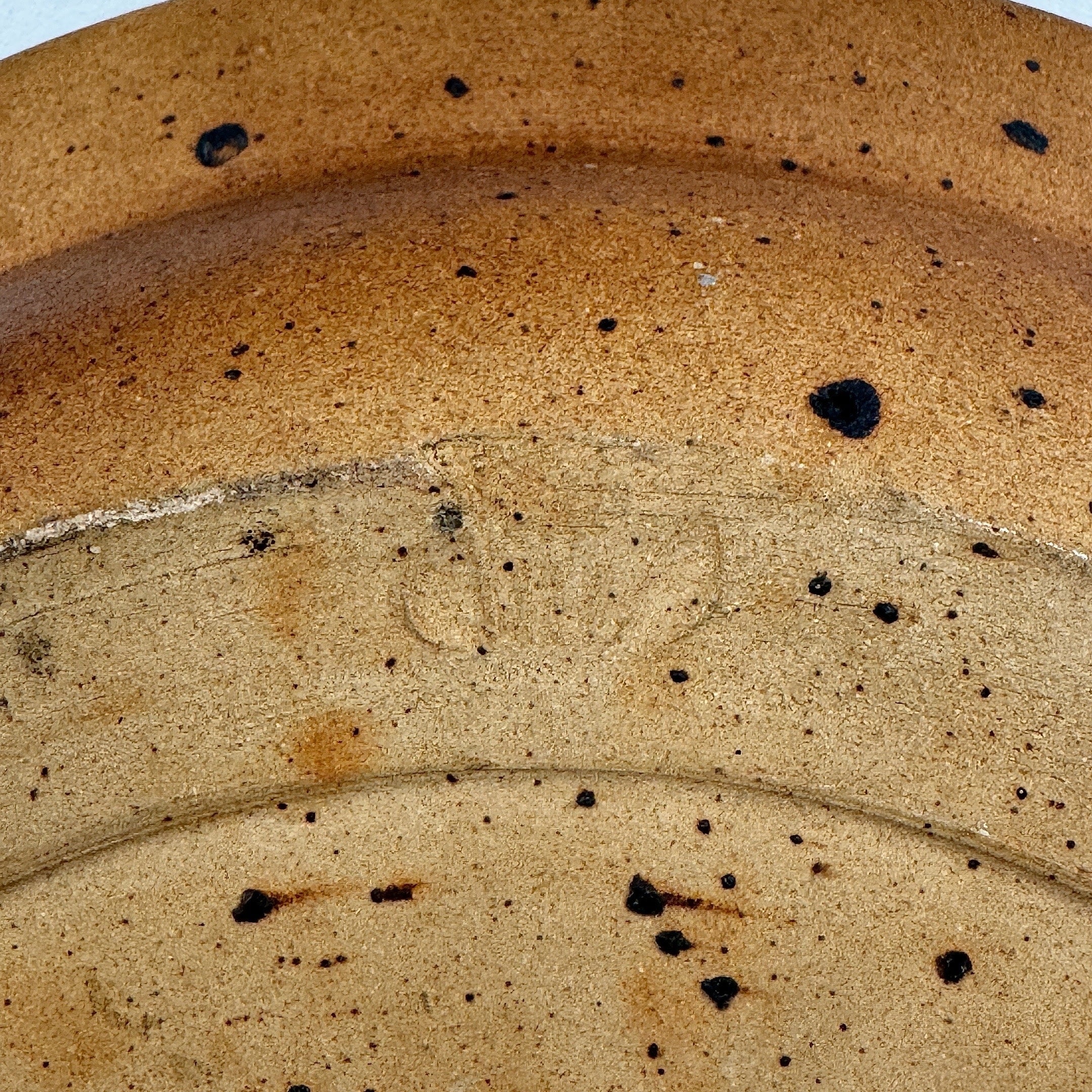 Close-up detail of stoneware bowl's speckled glaze texture