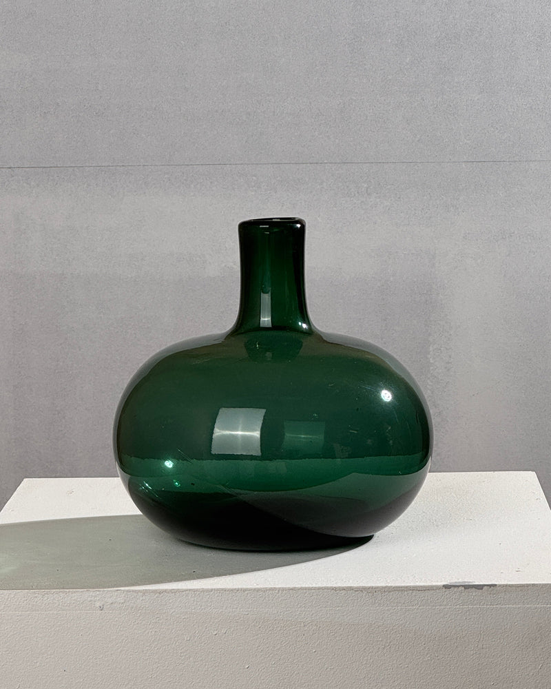 Green glass soliflore vase by Claude Morin showing rounded form