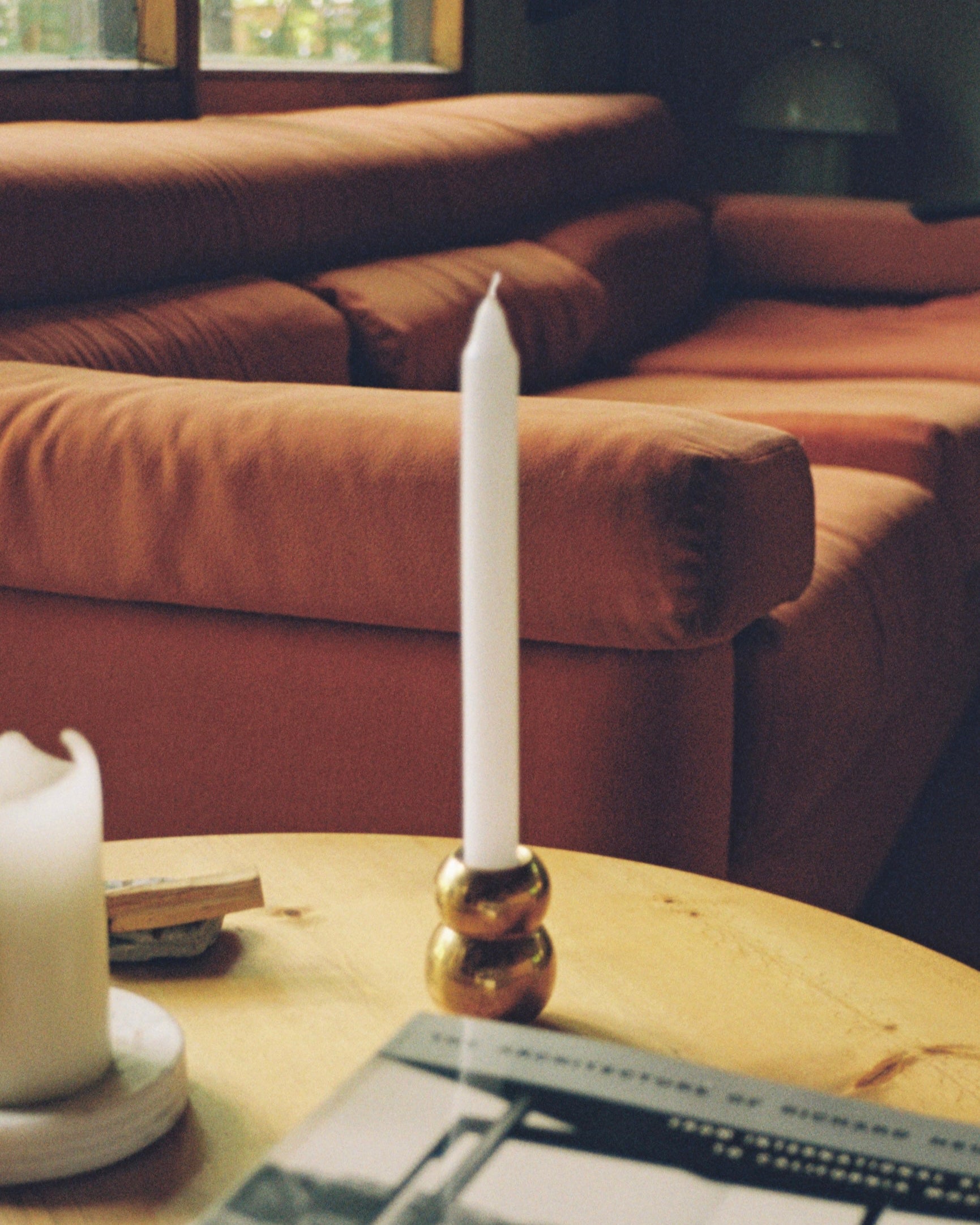 ANJOU Candleholder — gold metal base on wooden table with candle