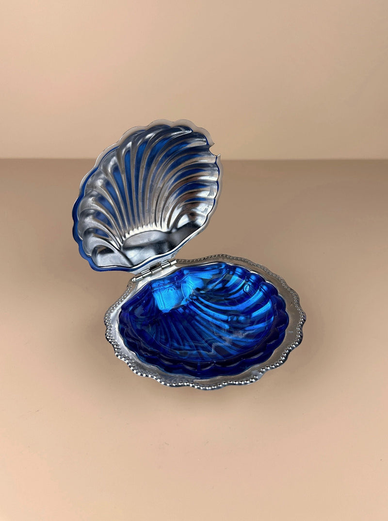 Beautiful ceramic shell shaped butter dish with intricate details and smooth finish 