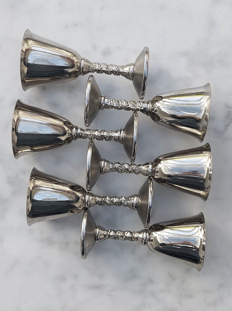 Six sleek and modern metal shot glasses for liquor