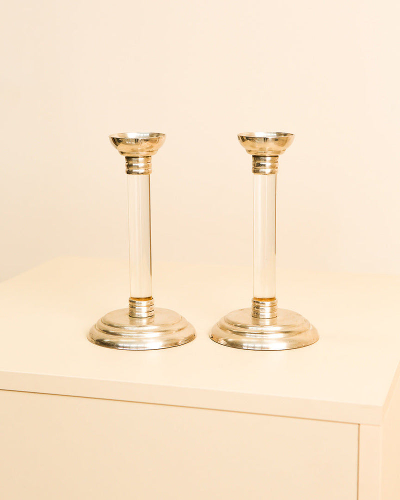 Pair of 1970s Italian silver and lucite candlesticks on beige surface