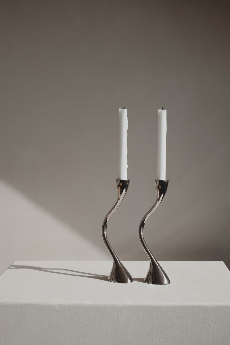 Pair of curved metal zigzag candleholders with white candles 1970s