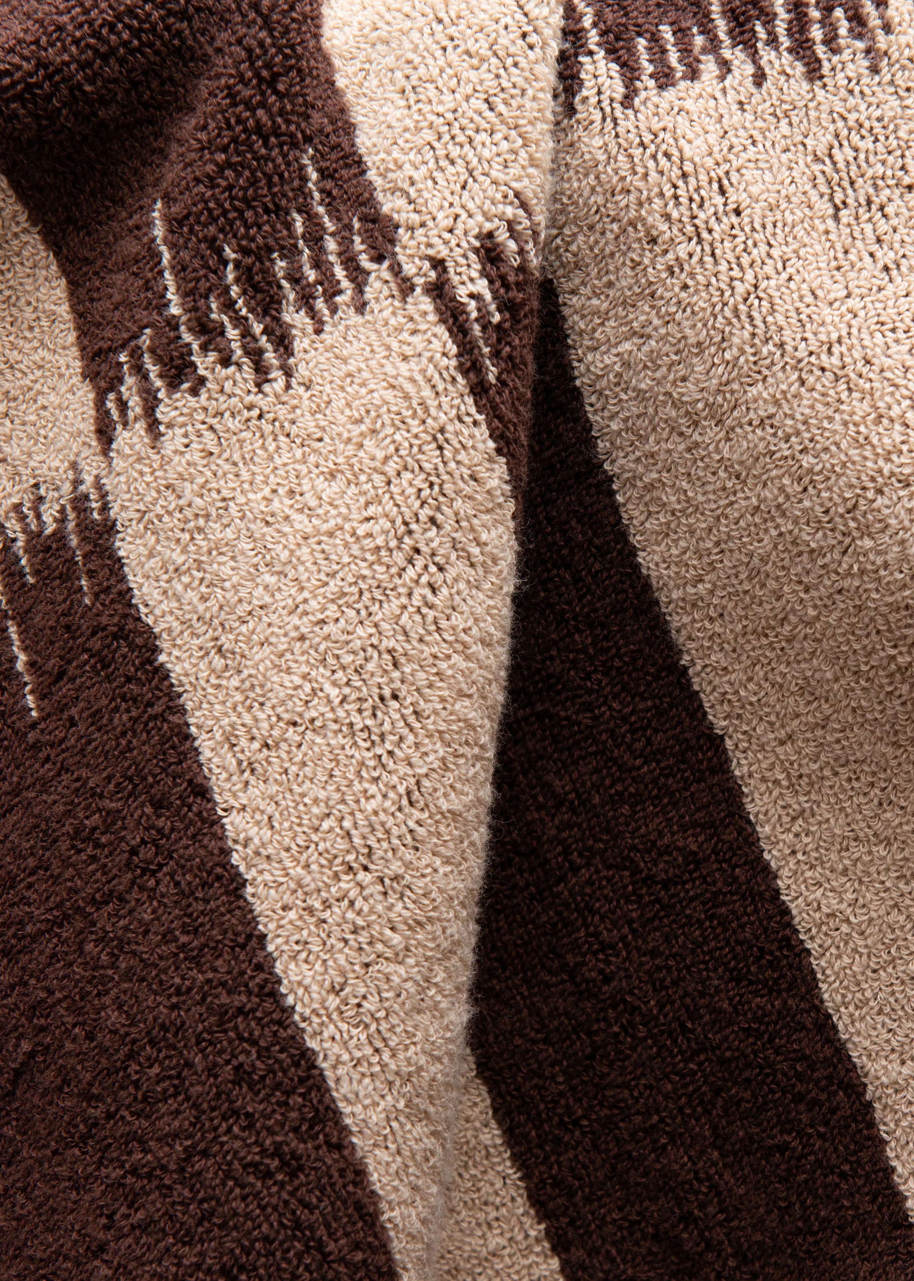 Close-up of a Karin Bath Towel from Autumn Sonata with alternating dark brown and beige stripes, showing the texture of the soft fabric.