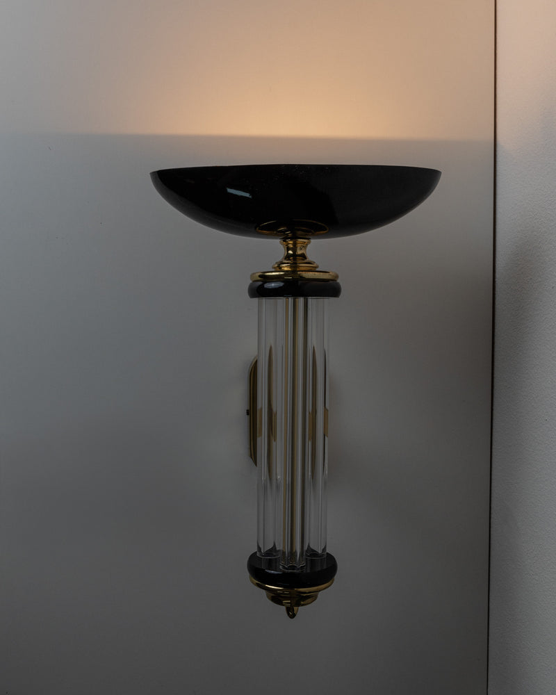 The Wall Light - Italy 1980s by Bottega Jacobs features a sleek black half-dome shade with vertical glass rods on a shiny gold fixture, delivering a Hollywood Regency design that casts a soft glow against a white wall.