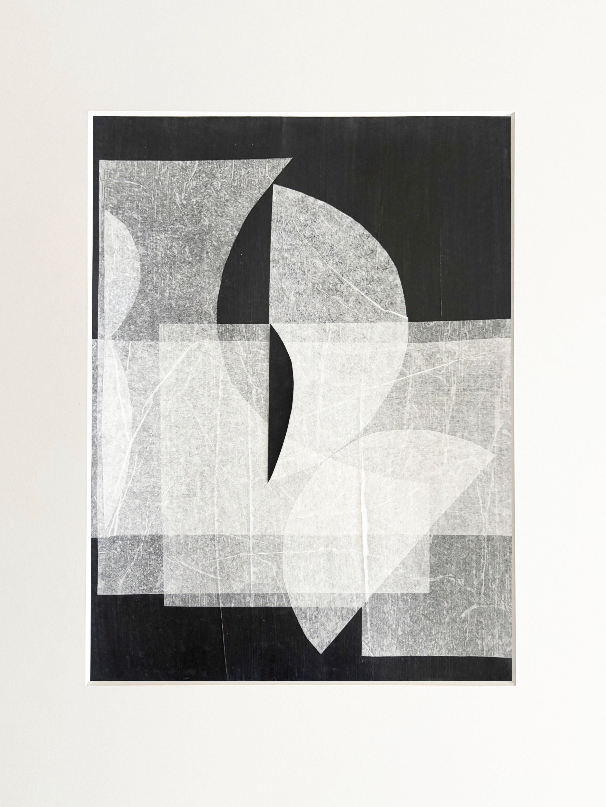 Abstract geometric mixed media artwork with overlapping circles and angular shapes in black, white and gray tones