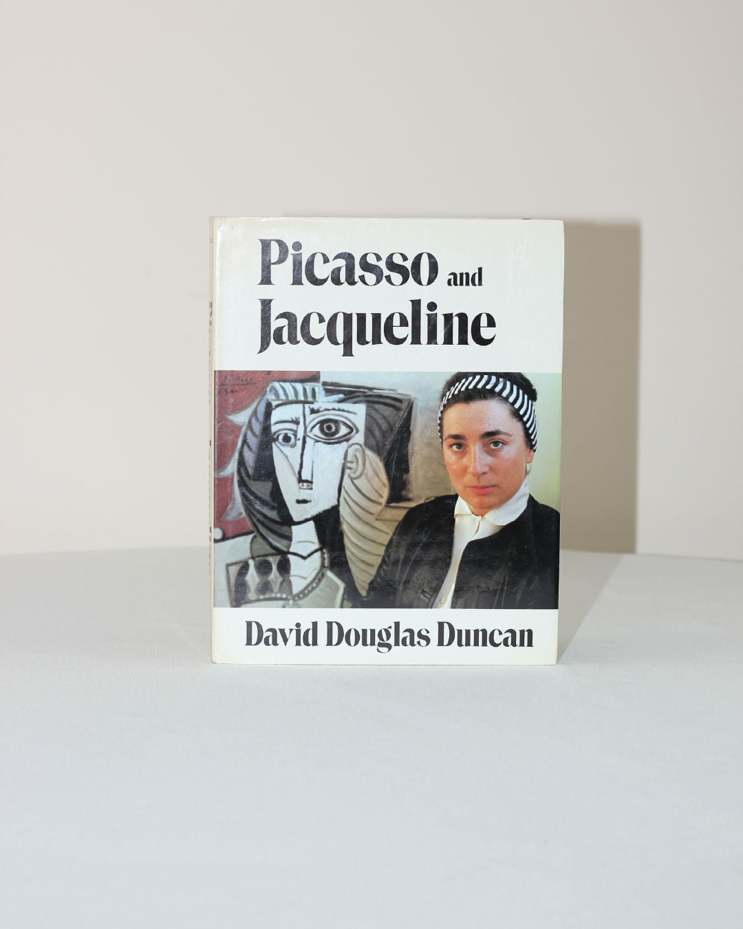 The image shows the book "Picasso and Jacqueline" from Boga Avante Shop, with a cover featuring Jacqueline’s photograph next to a Picasso-style portrait, both set against a white background.