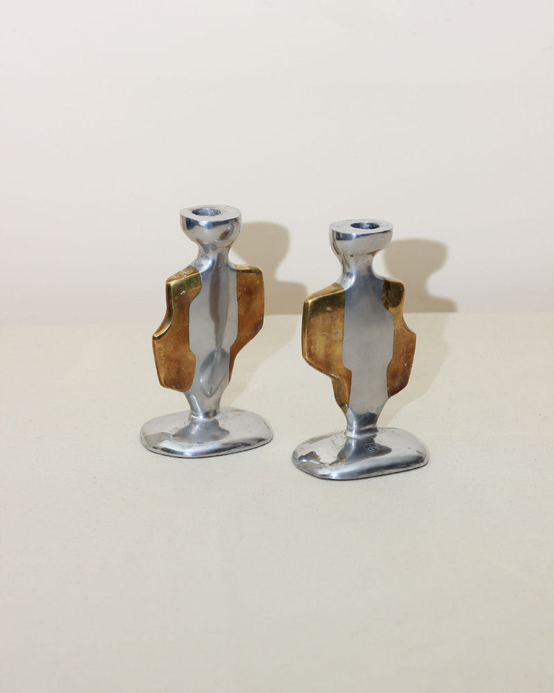 The Pair of Brutalist Candleholders by Boga Avante Shop feature abstract, sculptural aluminum and brass forms with gold accents, evoking vintage style and reminiscent of David Marshall designs.
