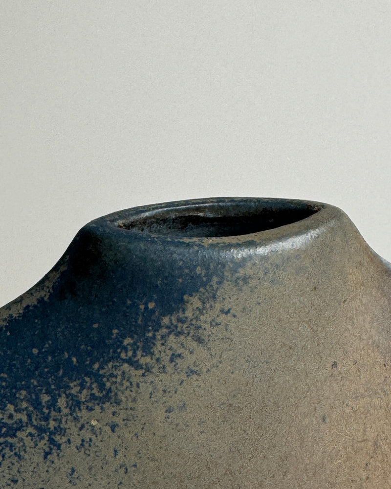 Close-up detail of blue speckled porcelain vase rim and surface
