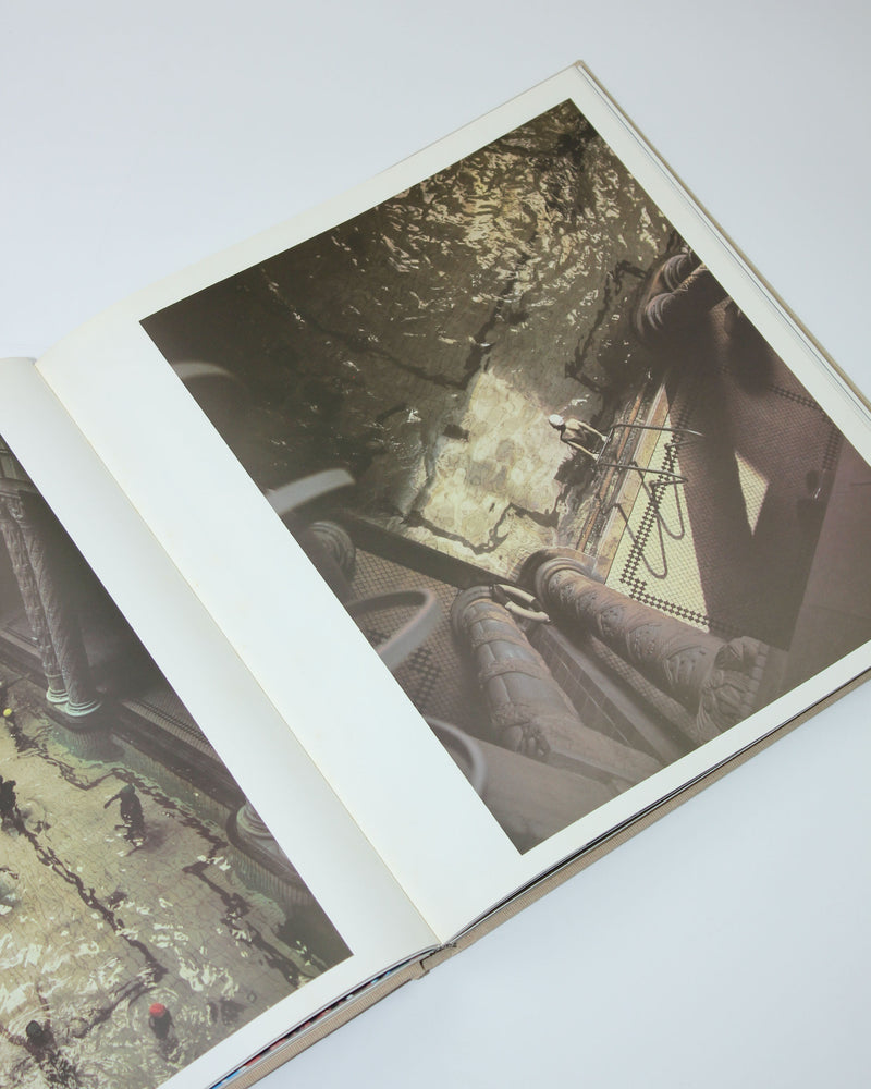 Industrial underwater facility with massive pipes and concrete structures from photography book