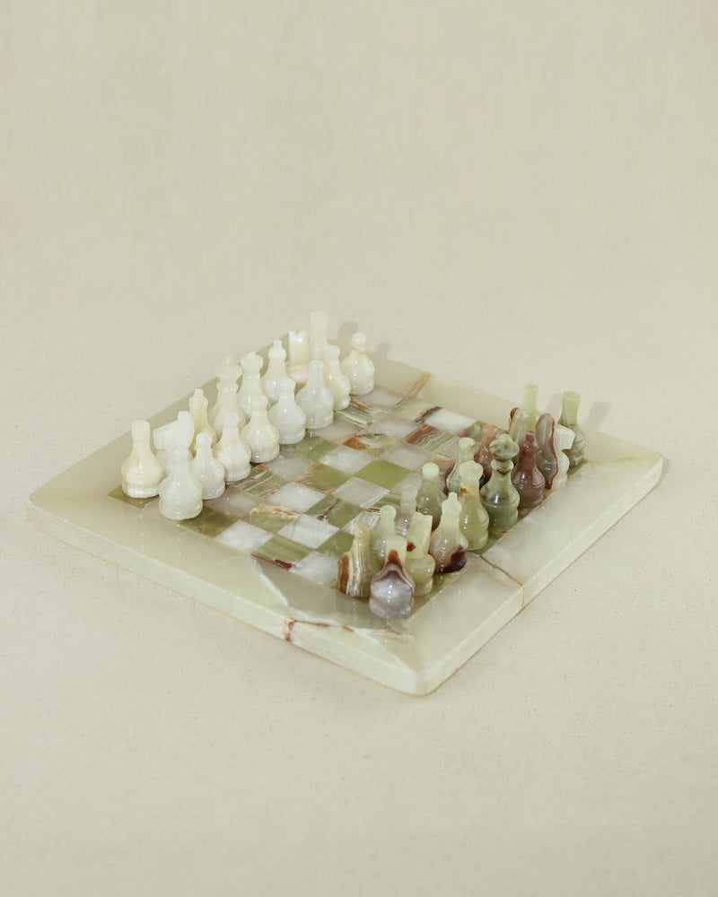 Luxury onyx chess set with carved pieces on marble board detail
