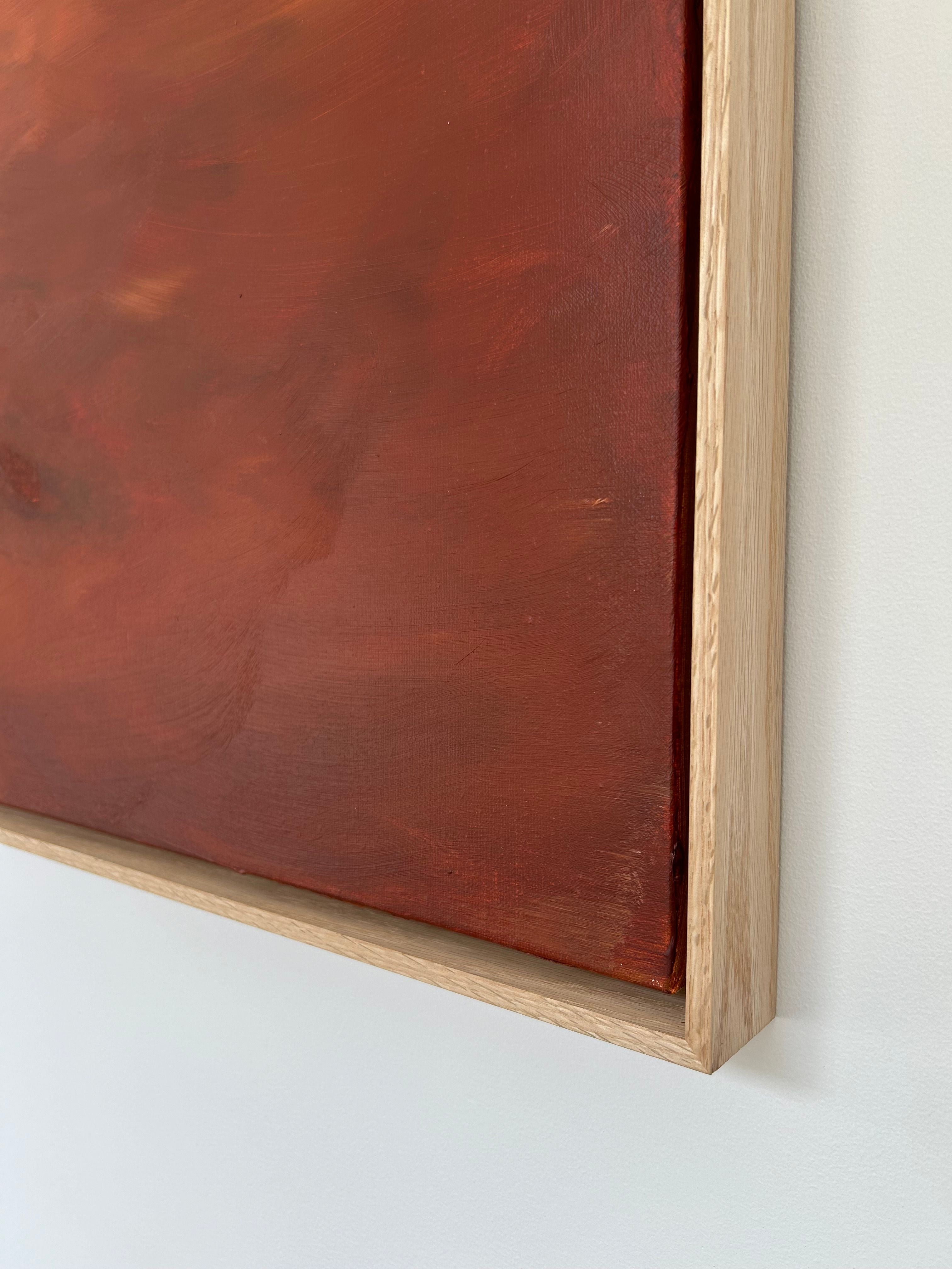 A close-up of the corner of a framed painting from Mattias Storm's Crimson Horizons - Mixed media on canvas series, featuring a warm, reddish-brown abstract design. The oak frame's light wood complements the mixed media artwork, and the image highlights the texture and detail of both painting and frame against a light wall.